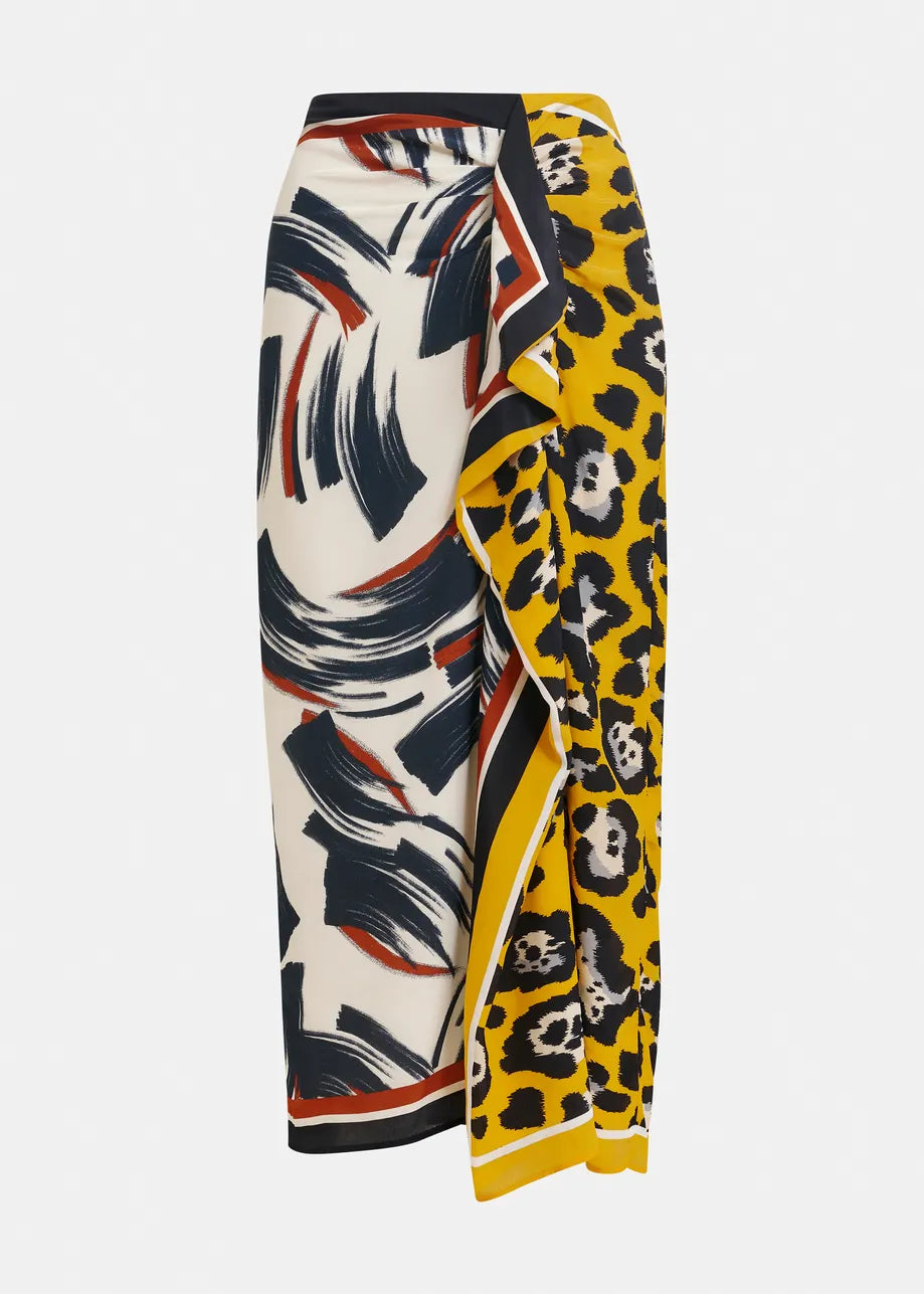 The Juanita Drape Midi Skirt by Essentiel Antwerp features a relaxed fit with an abstract navy and red brushstroke design on one side, a yellow leopard tropical print on the other, and a black, white, and yellow border.