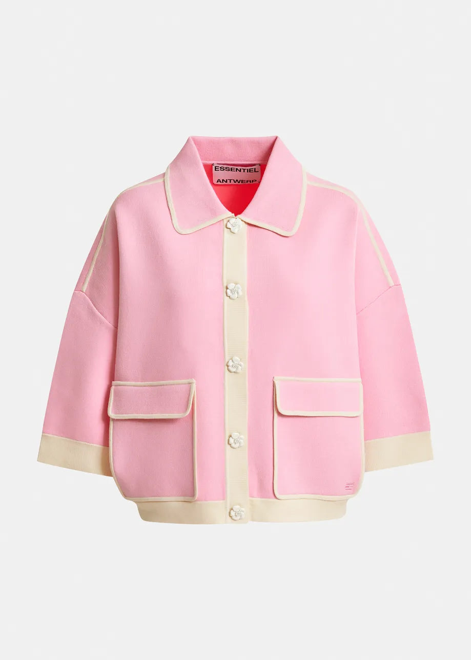 The Essentiel Antwerp Jugly Contrast Knit Cardigan in pink features cream trim, flower snap buttons, two large front pockets, and a collar, shown against a plain background.