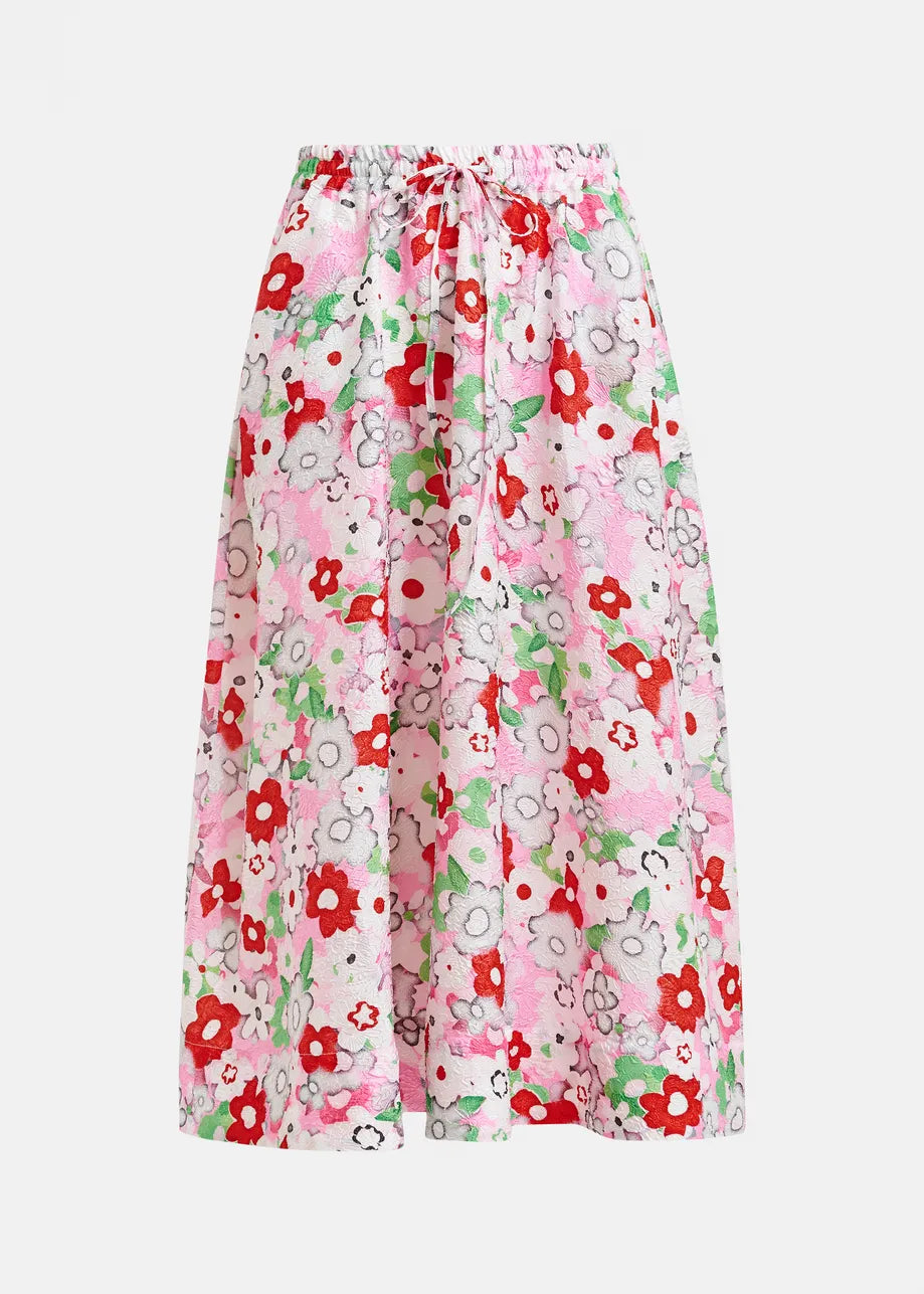 The Julianne Midi Skirt by Essentiel Antwerp features a pink A-line silhouette with red, white, and green floral print, plus an elastic waistband and front drawstring.