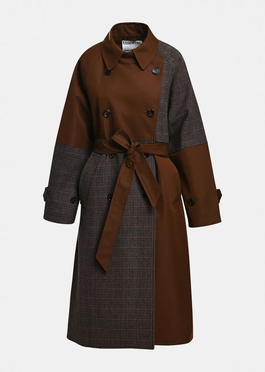 A double-breasted trench coat with a brown collar, double-breasted front, and a matching brown waist tie, featuring contrasting brown and dark gray patterned sleeves and side panels, shown on a light gray background. Essentiel Antwerp