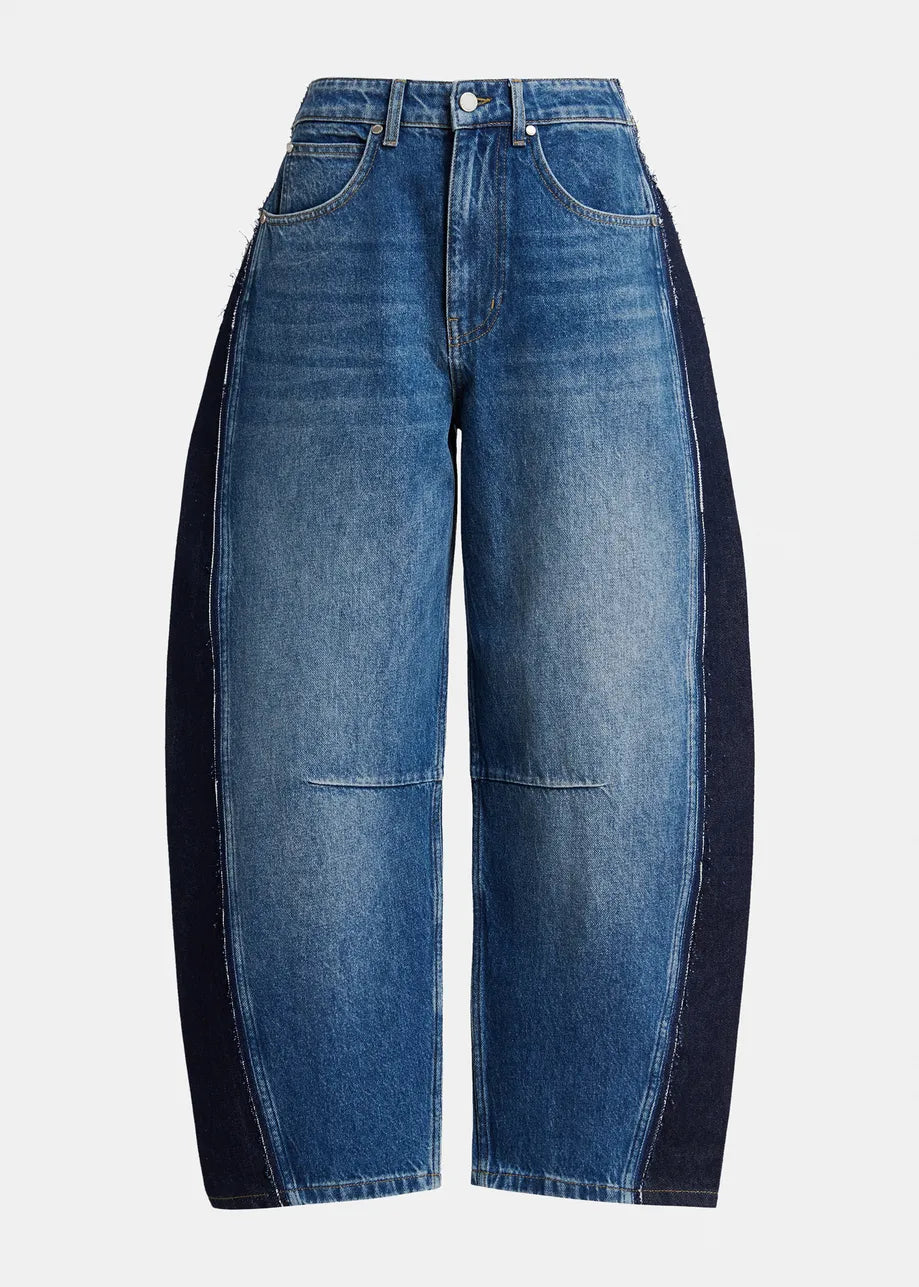 essentiel antwerp pair of barrel-leg blue denim jeans with contrasting dark navy side panels, shown against a plain light gray background.