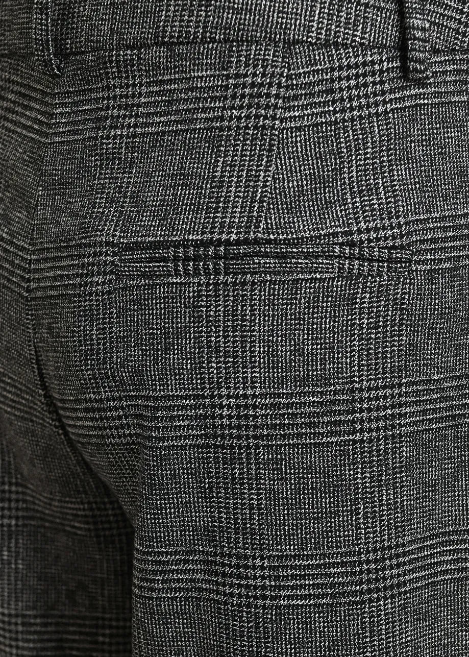 Close-up of the Kollection Checkered Wide-Leg Pants by Essentiel Antwerp in black and grey, highlighting the subtle check pattern, back pocket detail, and waistband. Crafted from recycled polyester, these wide-leg pants offer a relaxed silhouette for effortless style.