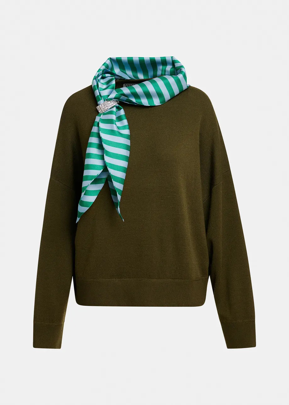 An olive green knit sweater with a green and white striped silk scarf tied around the neck, featuring a small silver-tone brooch, shown against a plain light gray background.
