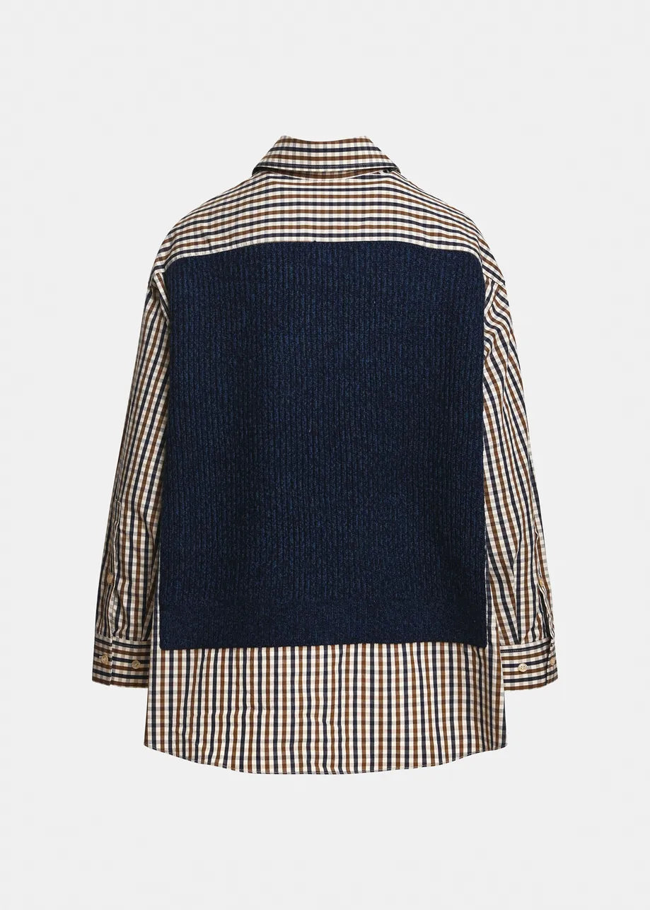 Back view of the Essentiel Antwerp Kute Fabric Mix Shirt, crafted from organic cotton with a blue textured panel across the upper back and a checkered beige, navy, and white pattern on the rest of the fabric, finished with a deconstructed layered effect for an oversized silhouette.
