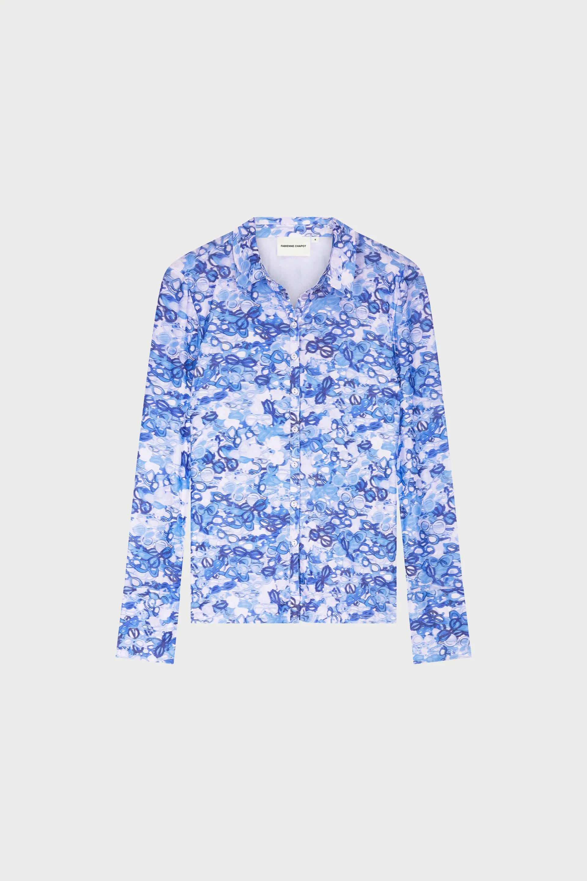 The Fabienne Chapot Kevis Blouse - Blue features a fitted silhouette with long sleeves and showcases an abstract blue and white floral print on a light background.