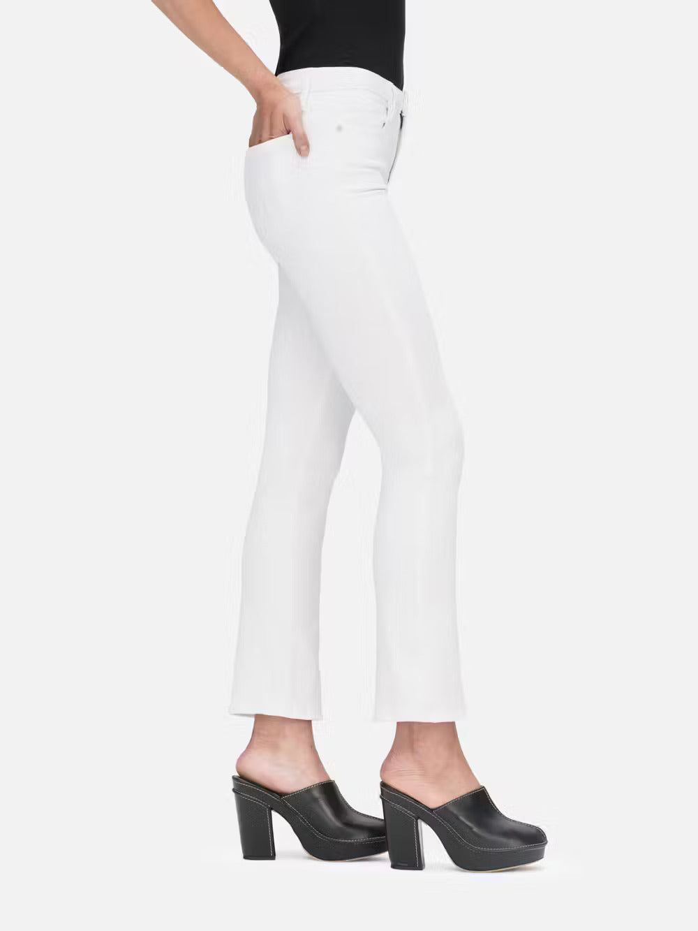 A woman wearing Le High Straight - Blanc jeans by Frame and black heels.
