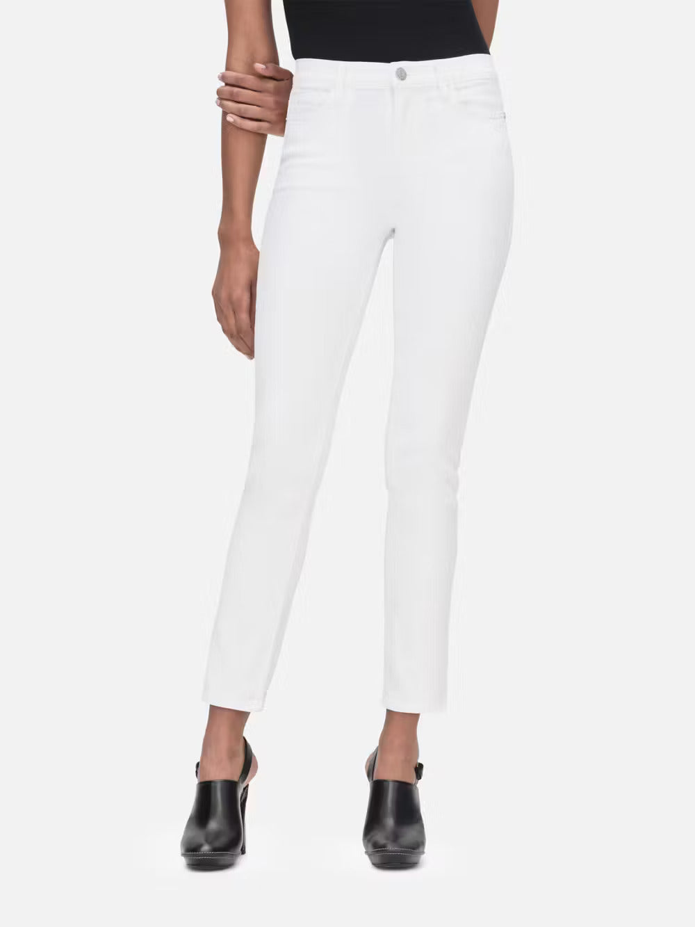 A woman wearing Frame's Le High Straight - Blanc denim jeans and a tailored black top.