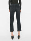 woman wears black top and blazer with a high rise washed black denim jean with a straight leg and raw hem at the ankle, showing back view