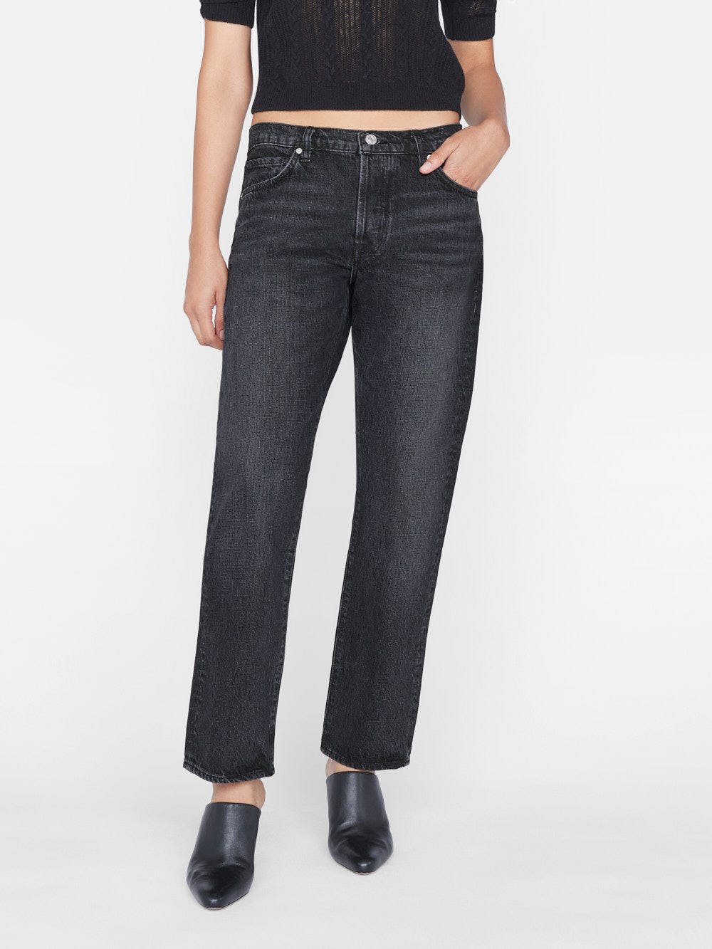 A woman wearing sustainable denim, Frame - Le Slouch Pompei jeans.