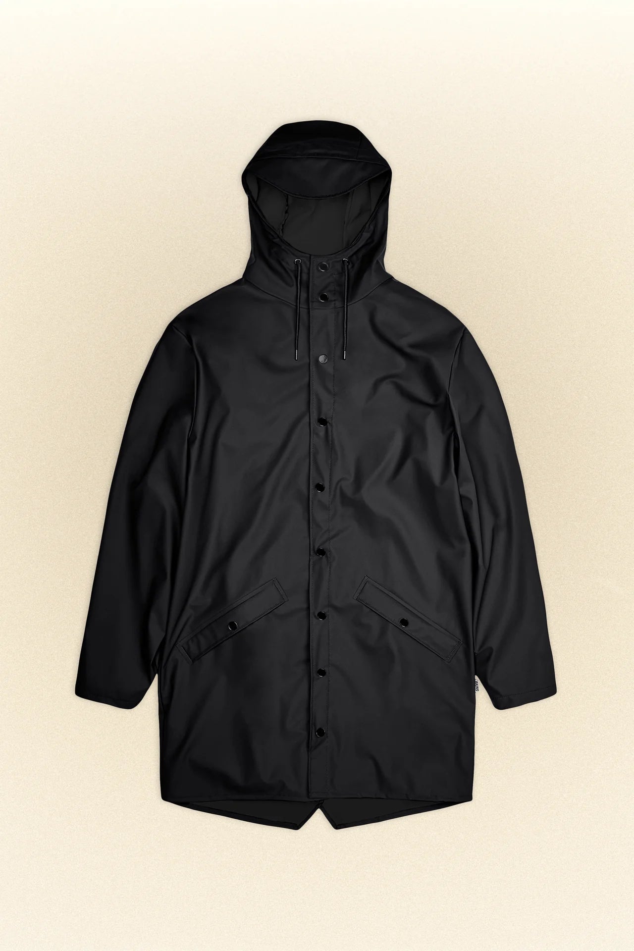 Image of a black Long Jacket - Core Colours, crafted from Rains' signature PU fabric, laid flat. This unisex rain jacket features a front button closure and two large pockets, ensuring both style and function.