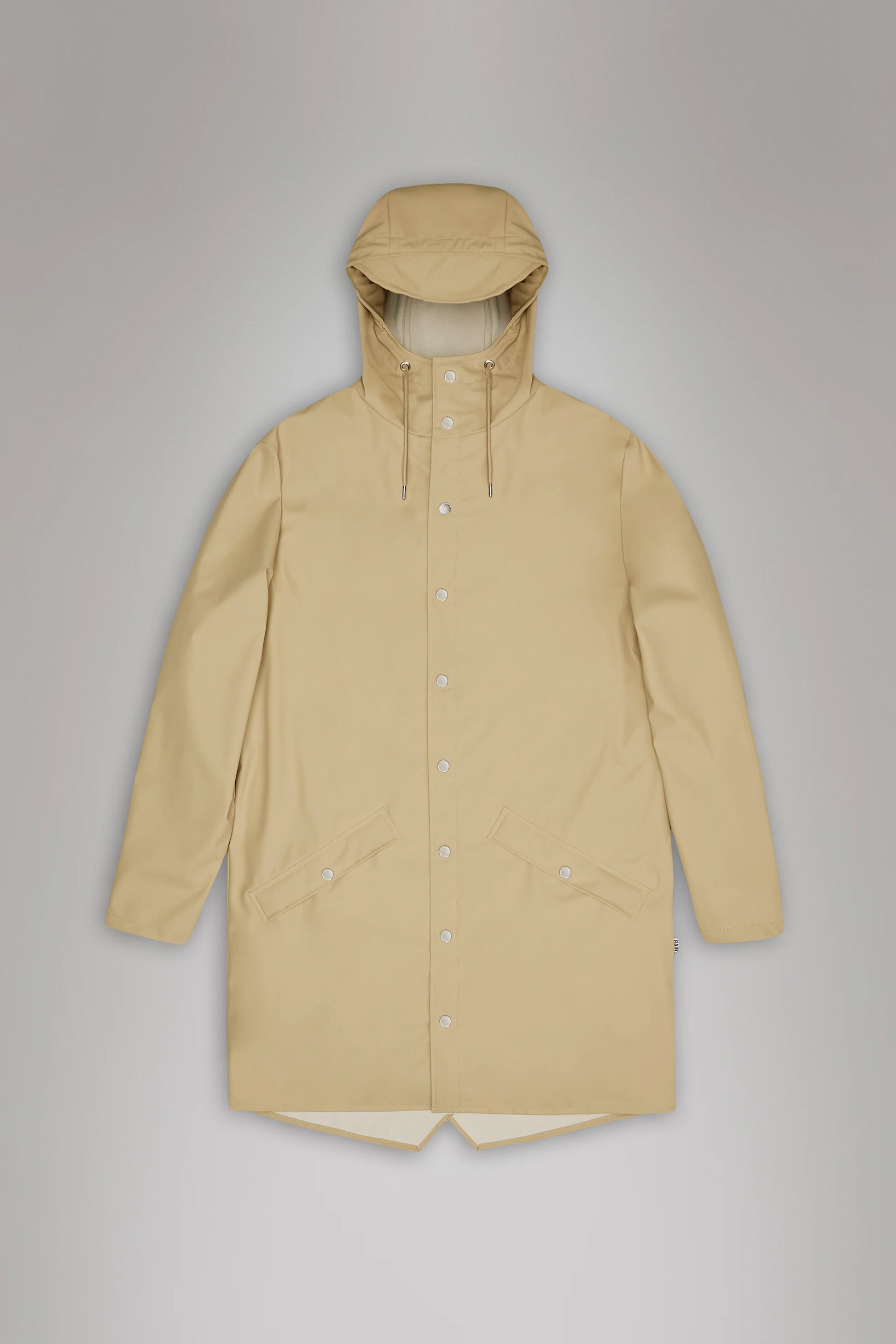 A Long Jacket - Core Colours from Rains, made with their signature PU fabric in beige, featuring a hood, front snap buttons, and two large front pockets is laid flat on a gray surface.