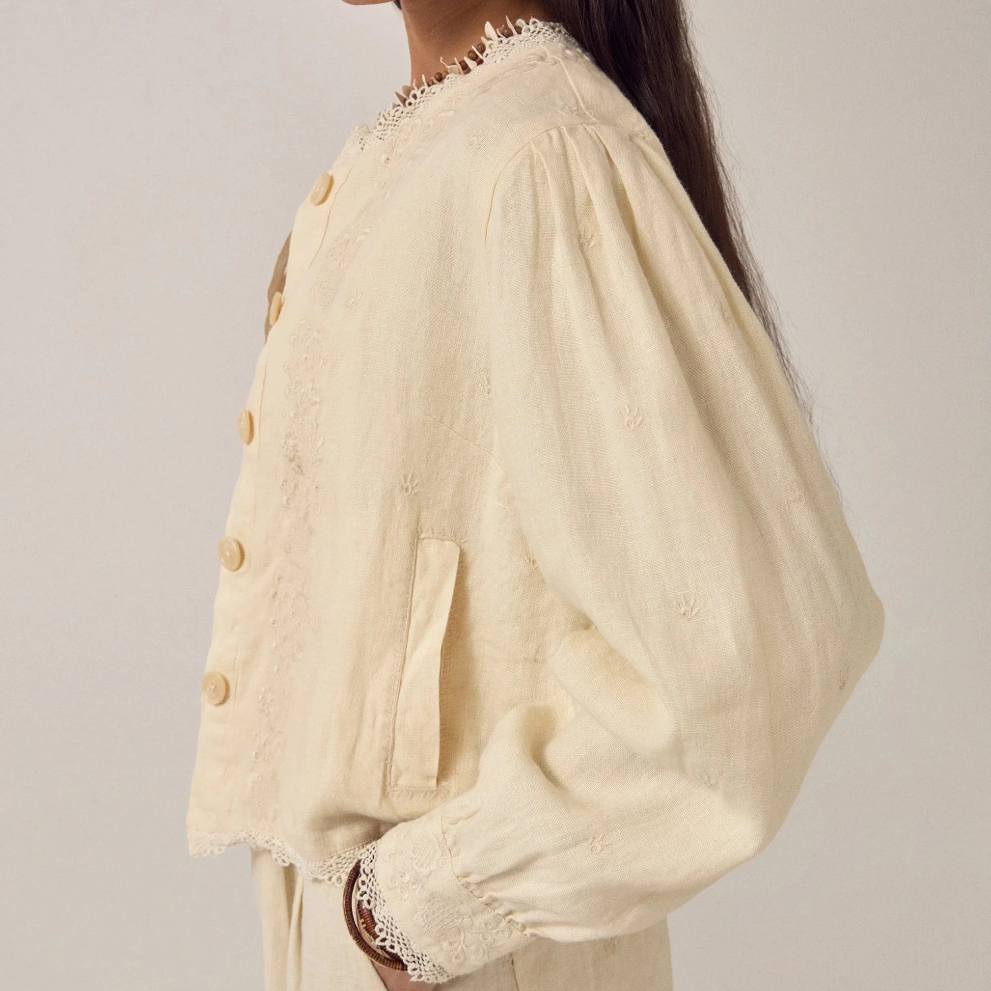 woman wears maison hotel otelo cotton and linen summer jacket in cream with linen trousers on na white background