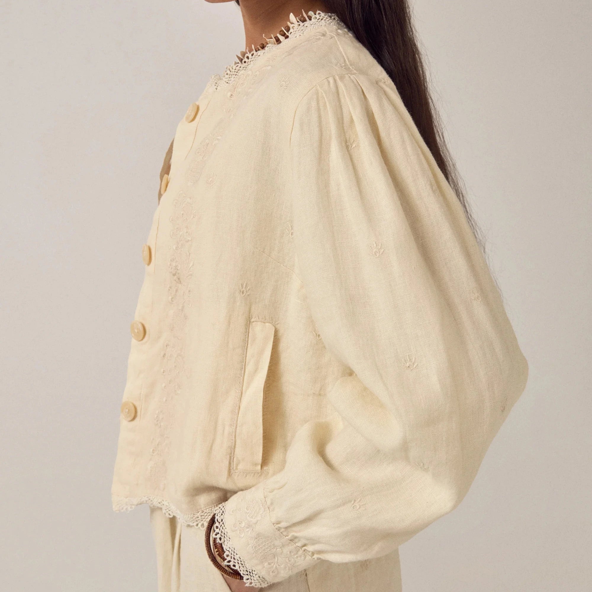 woman wears maison hotel otelo cotton and linen summer jacket in cream with linen trousers on na white background
