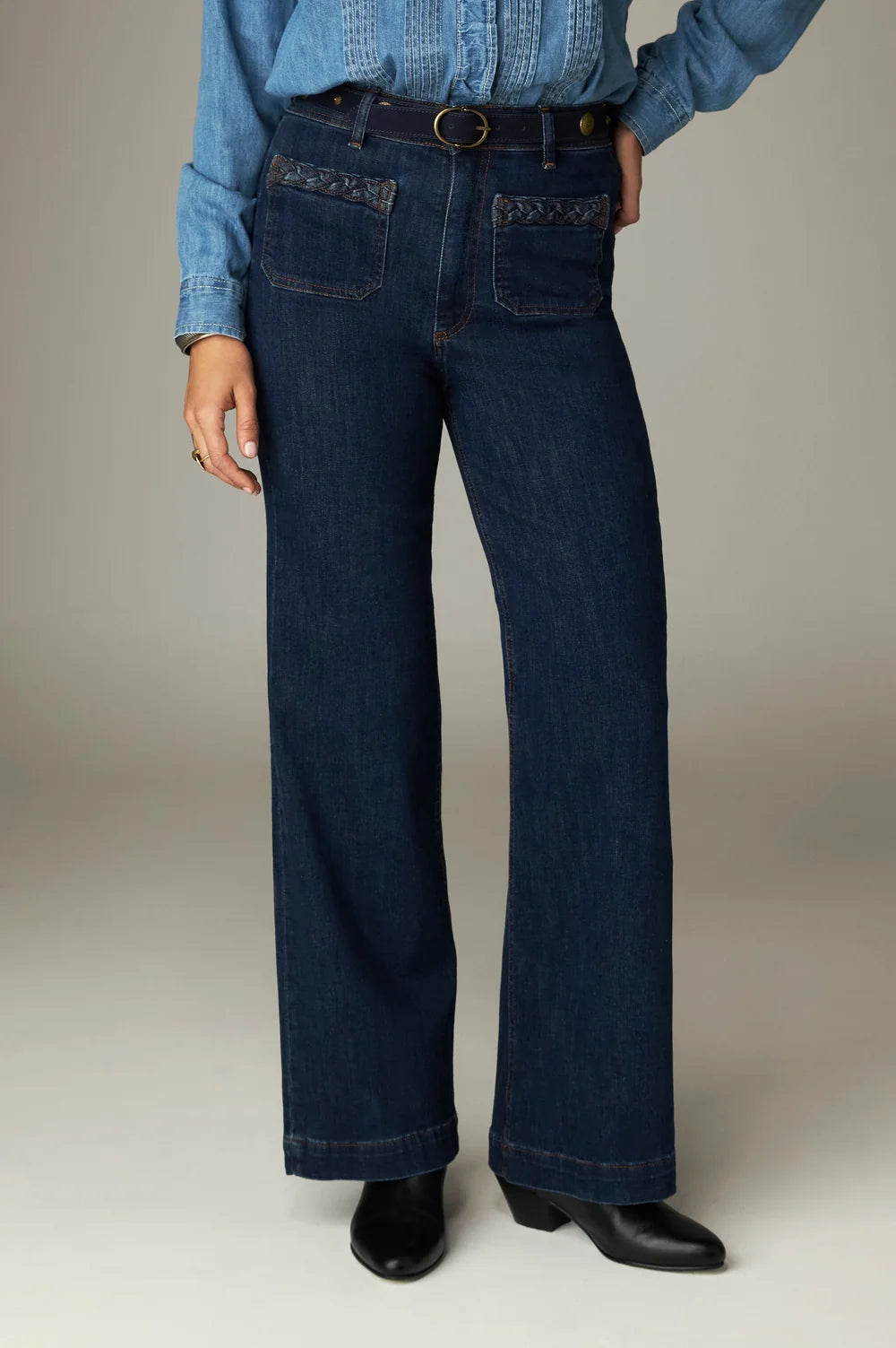 Maison Hotel Giulietta Pant in high-waisted, dark blue wide-leg denim, featuring front patch pockets with braided trim.