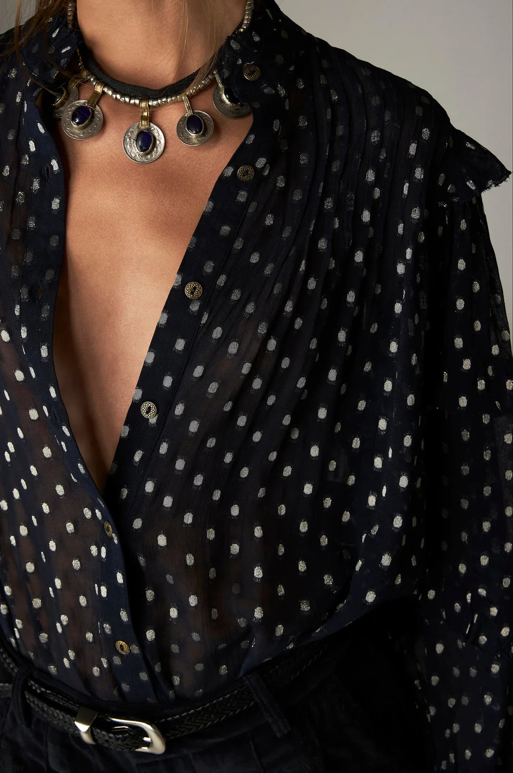 Maison Hotel Simona Blouse - Sienna navy: a semi-sheer metallic jacquard blouse with silver polka dots and pleated ruffle detailing, worn with a chunky silver coin necklace.