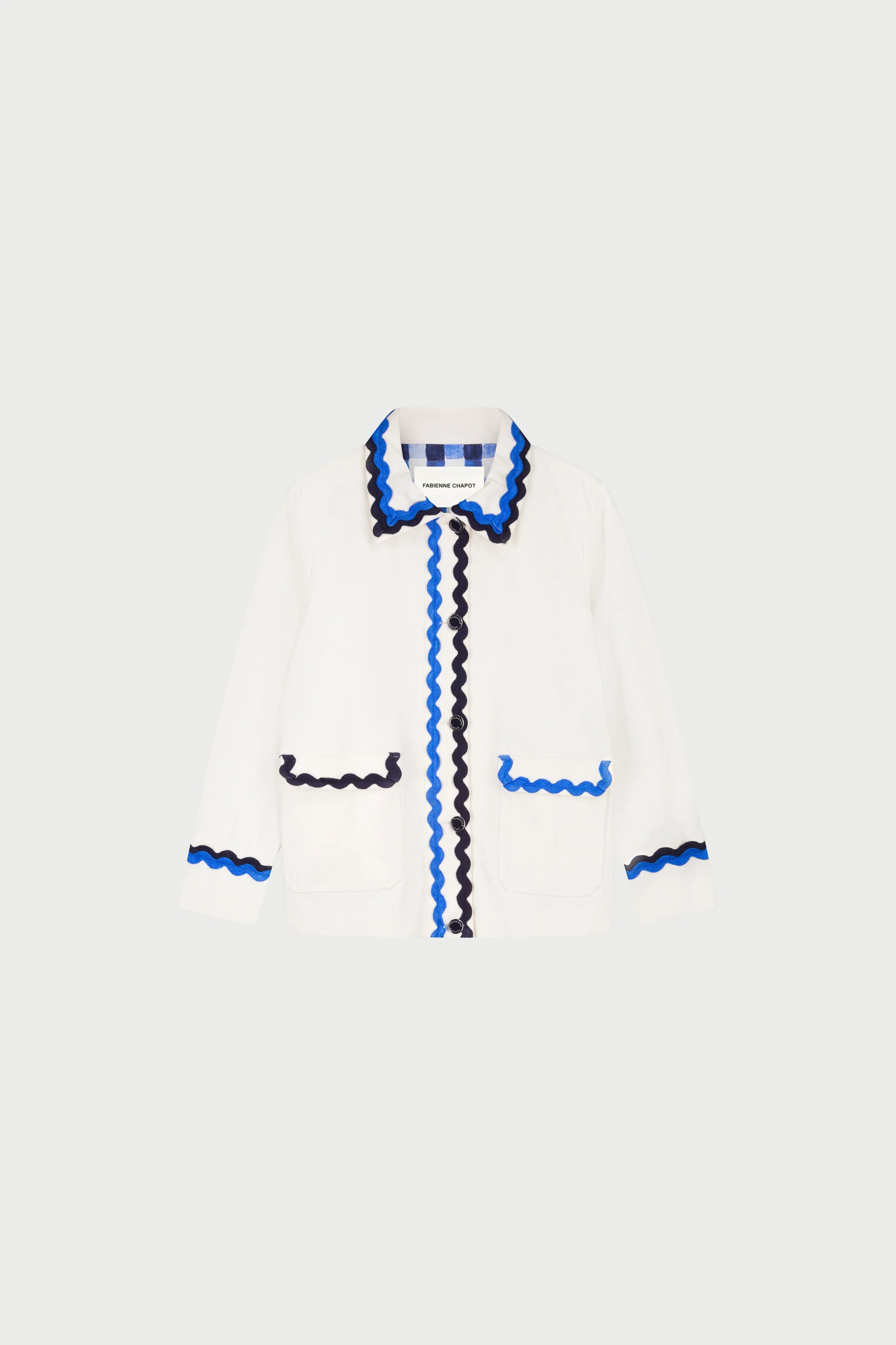 The Fabienne Chapot Melodie Jacket - Warm White is a versatile cotton jacket with blue and black wavy trim on the collar, front, cuffs, and pockets, shown against a plain light background.