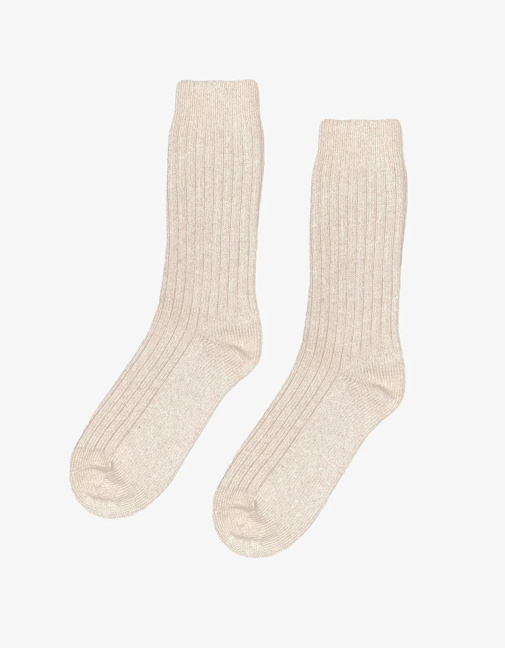 A pair of Colorful Standard Merino Wool Blend Socks in beige are displayed on a plain white background.