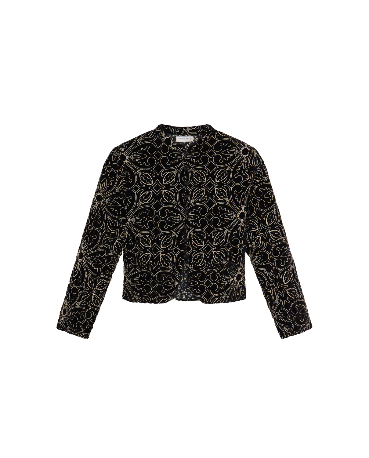 The Odette Jacket - Nero by Maison Hotel is a black velvet jacket with long sleeves and delicate light floral embroidery, displayed on a white background.
