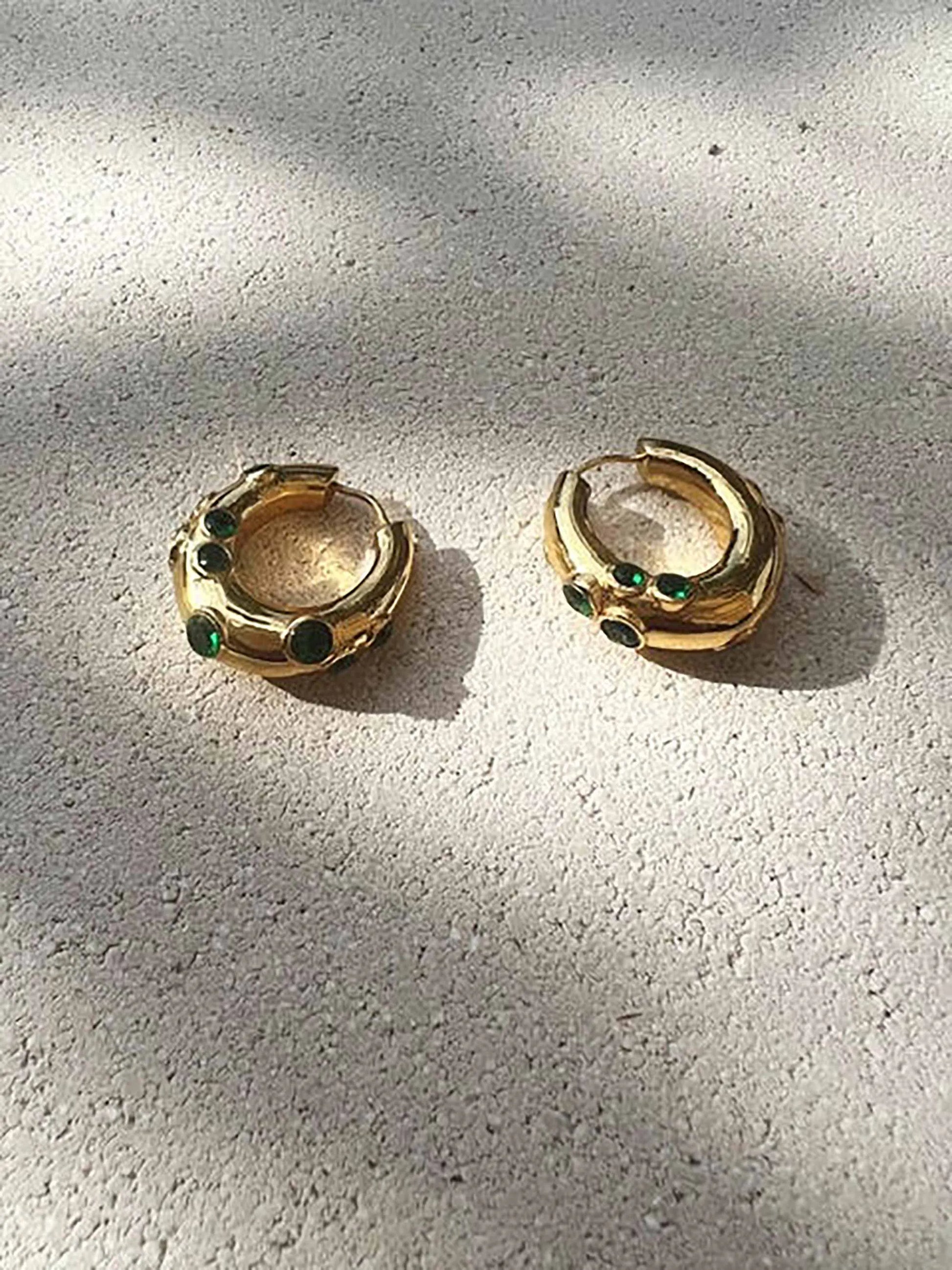 A pair of SHYLA - Oren Hoops - Gold earrings with emerald stones.