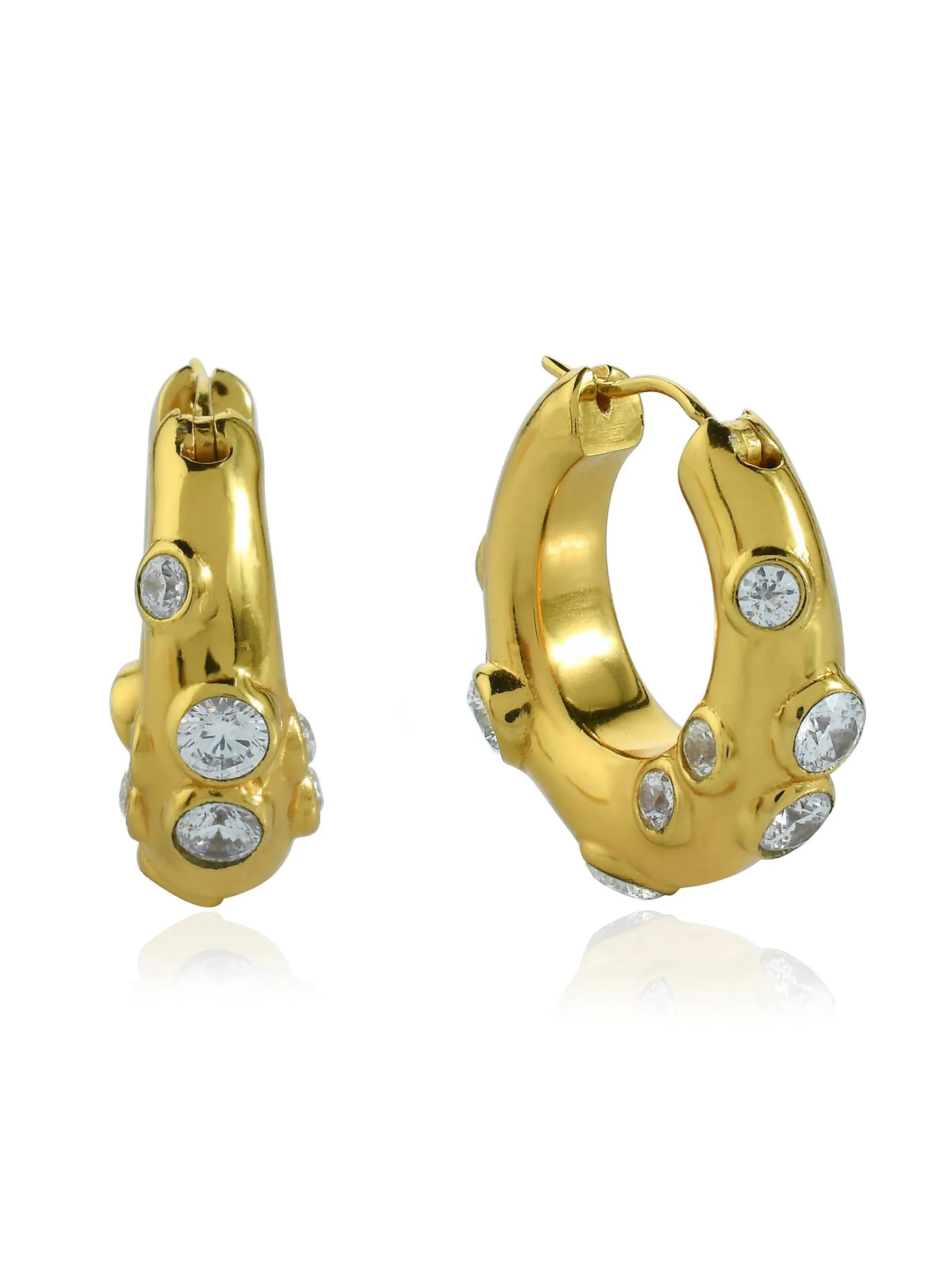A pair of yellow gold Shyla Oren hoops adorned with diamonds.
