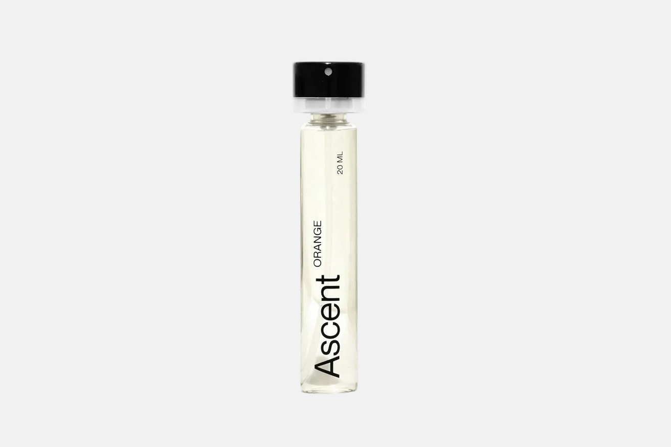 Ascent Refillable Perfume - Orange in a slender glass cylinder with a black cap, labeled “20 ml.”