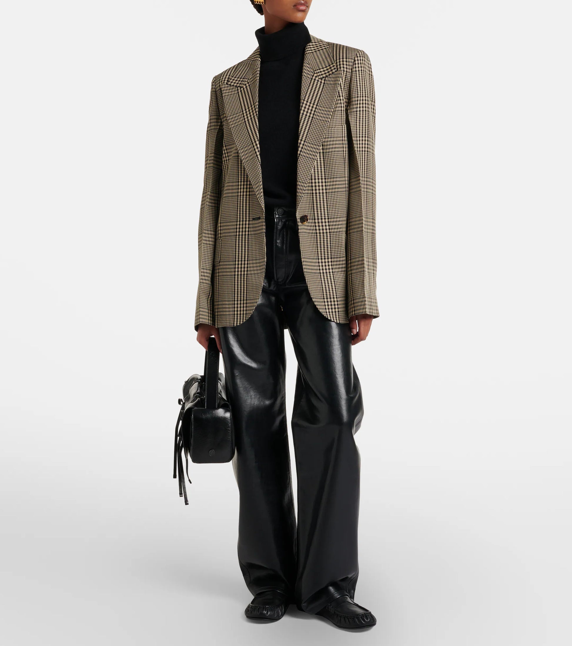 A person is wearing a plaid blazer, black turtleneck, and the AGOLDE Arc Jean 32 Wide Leg Trousers - Detox, styled with a small black handbag.