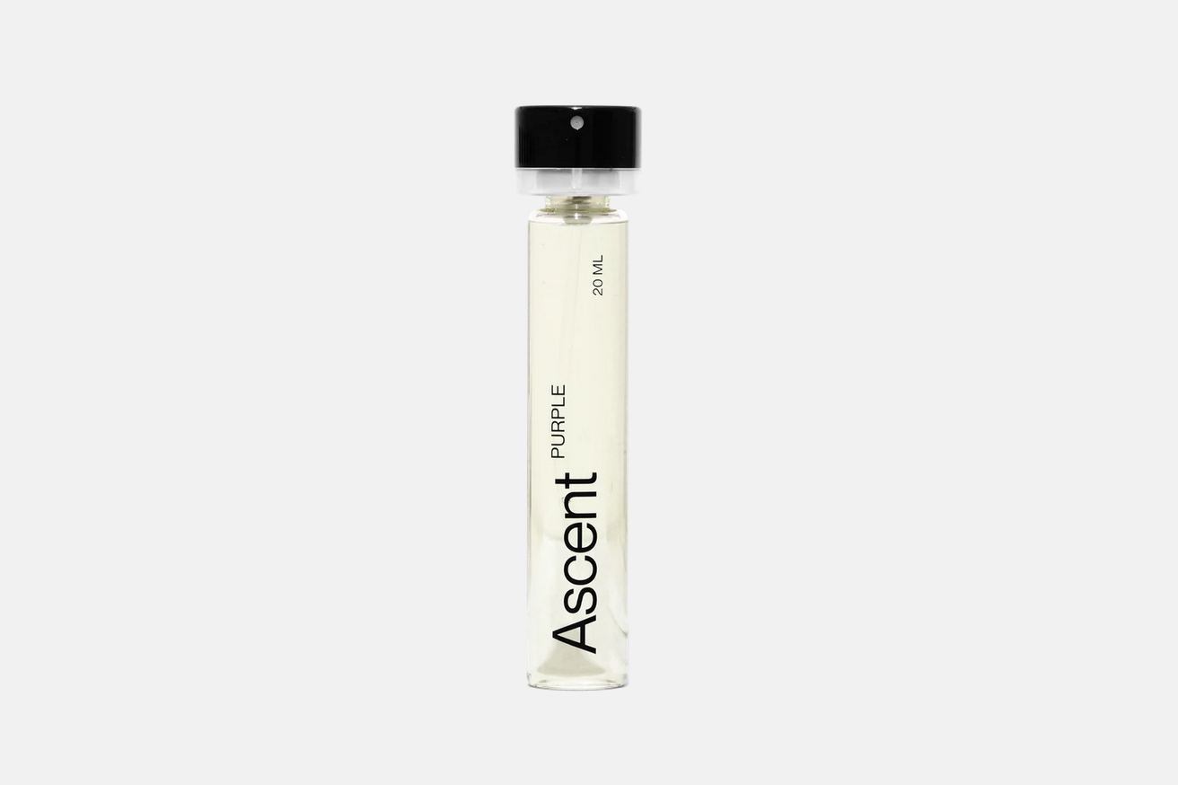 A cylindrical purple Ascent Refillable - Purple perfume extract bottle with a black cap, labeled “Ascent,” “Purple,” and “20 ml.”