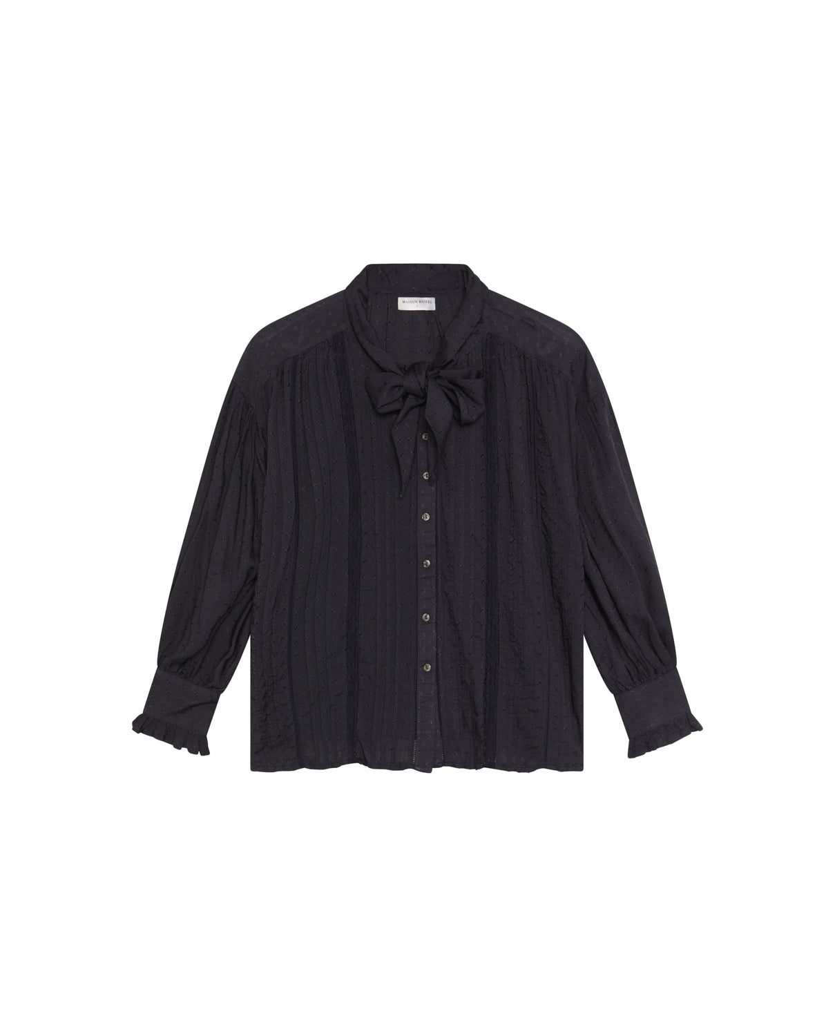 The Lorraine Blouse - Twilight by Maison Hotel features long sleeves, textured stripes, a button front, bow tie neckline, and ruffled cuffs, shown on a plain white background.