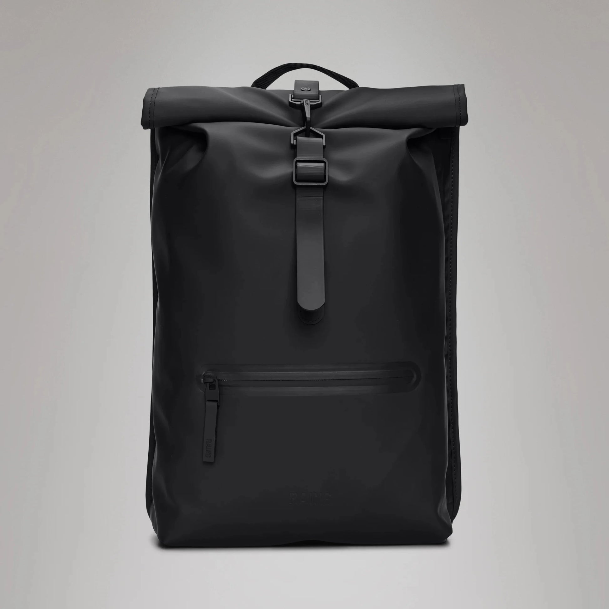 Image of a sleek, black Rolltop Rucksack by Rains featuring a front zipper pocket, side-access laptop pocket, and carrying handle. Made from waterproof PU fabric for ultimate durability and style.