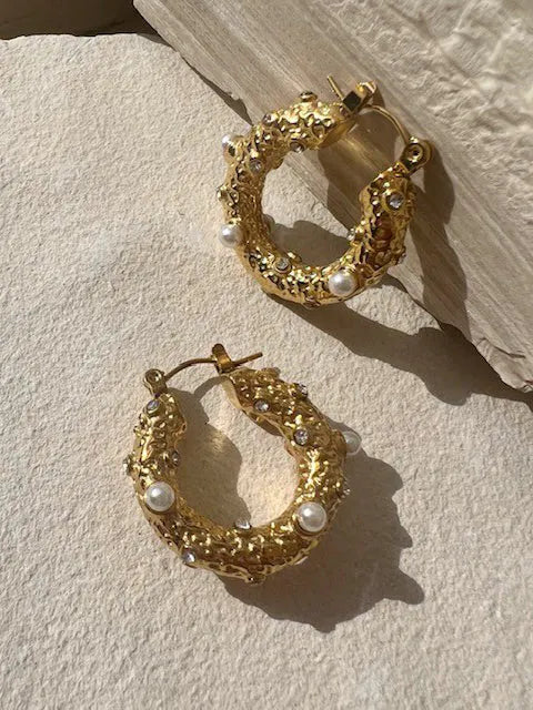 A pair of SHYLA - Sirius Hoops- Gold earrings adorned with pearls.