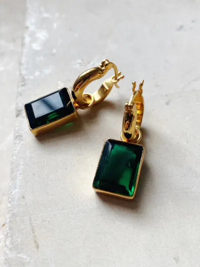 A pair of high shine gold plated SHYLA Sorrento Hoops with emerald green stones.