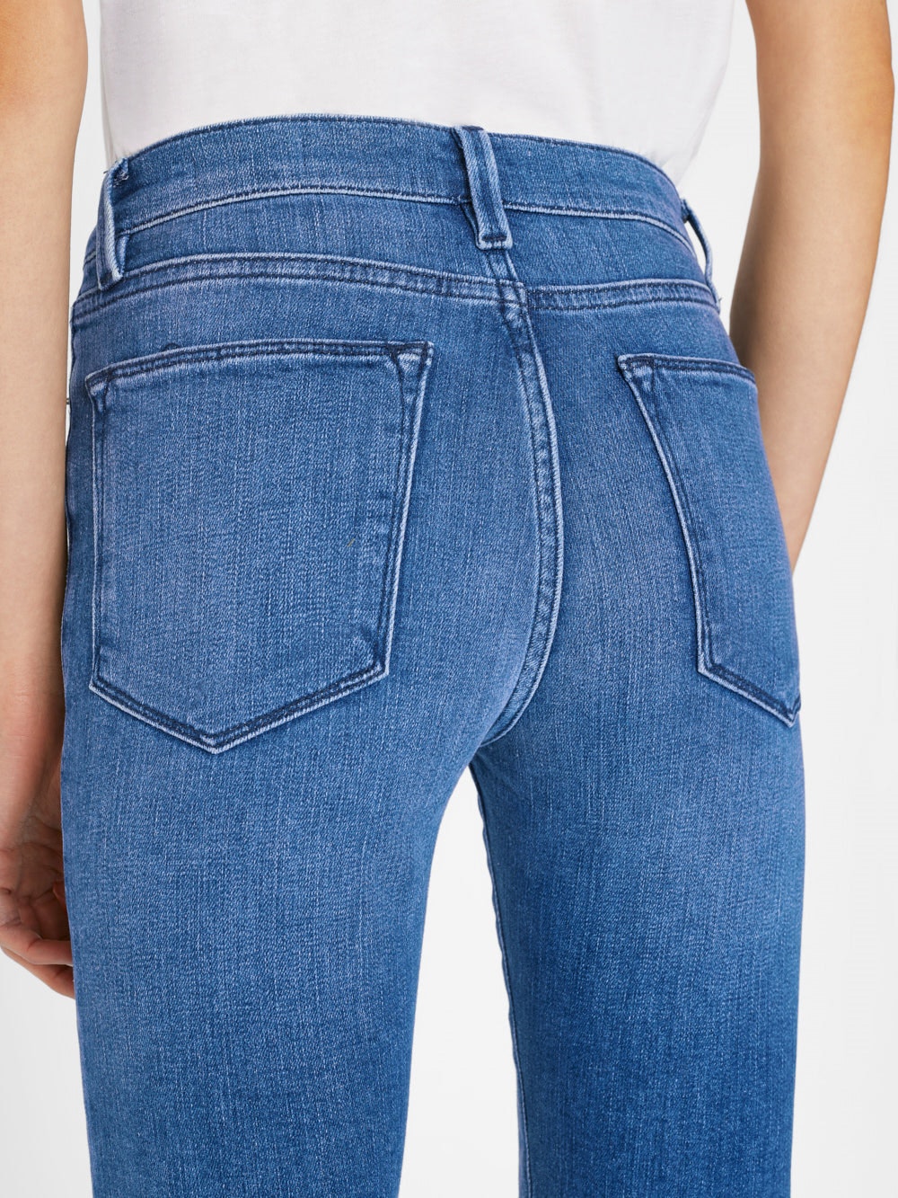 The back view of a woman in Frame's Le High Straight - Temple blue jeans.