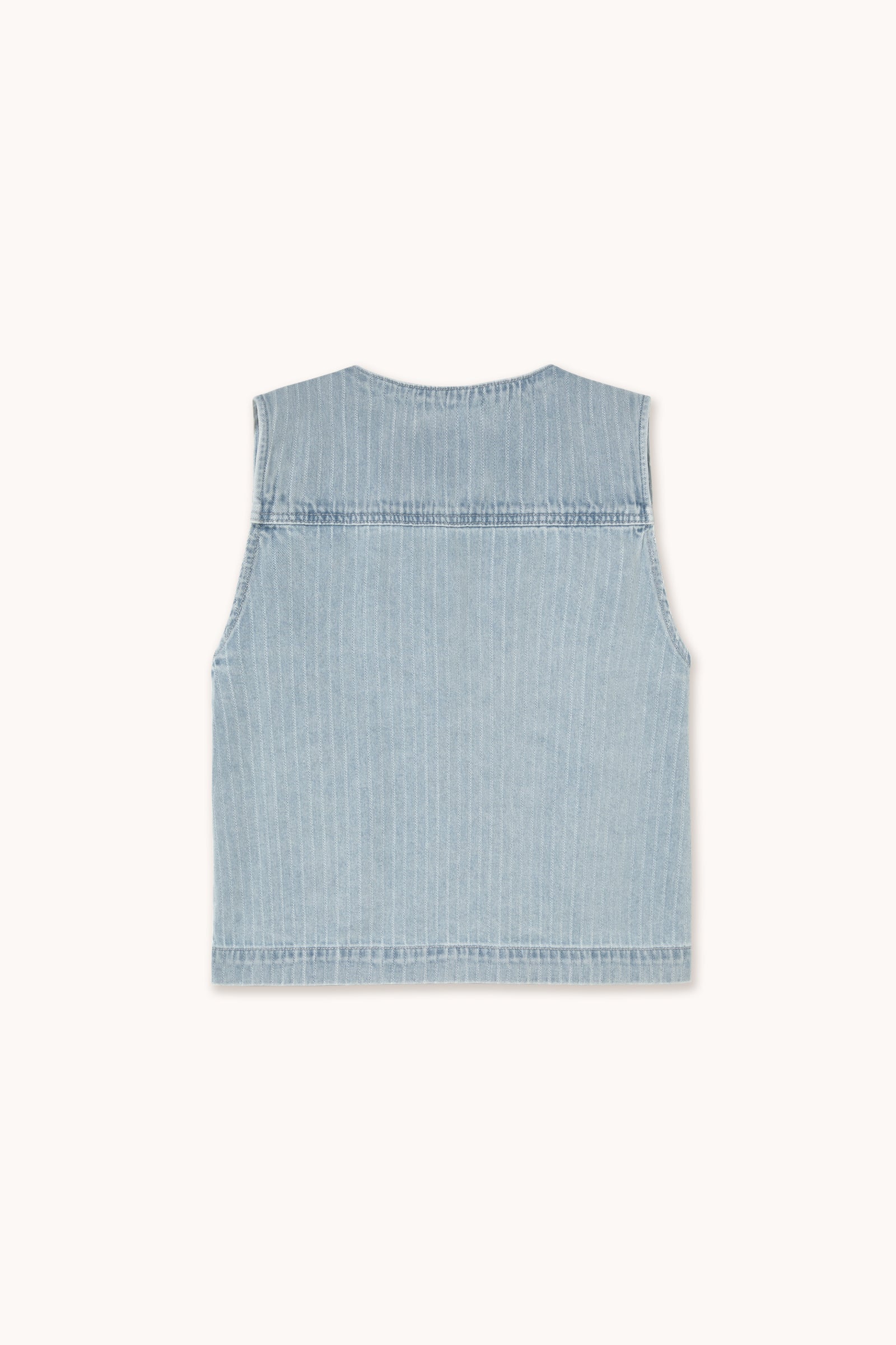 The Tiny Big Sister Denim Tie-Vest in light blue is shown from the back, crafted in light-wash pinstripe denim with vertical seams, a straight hem, and a sleeveless design.