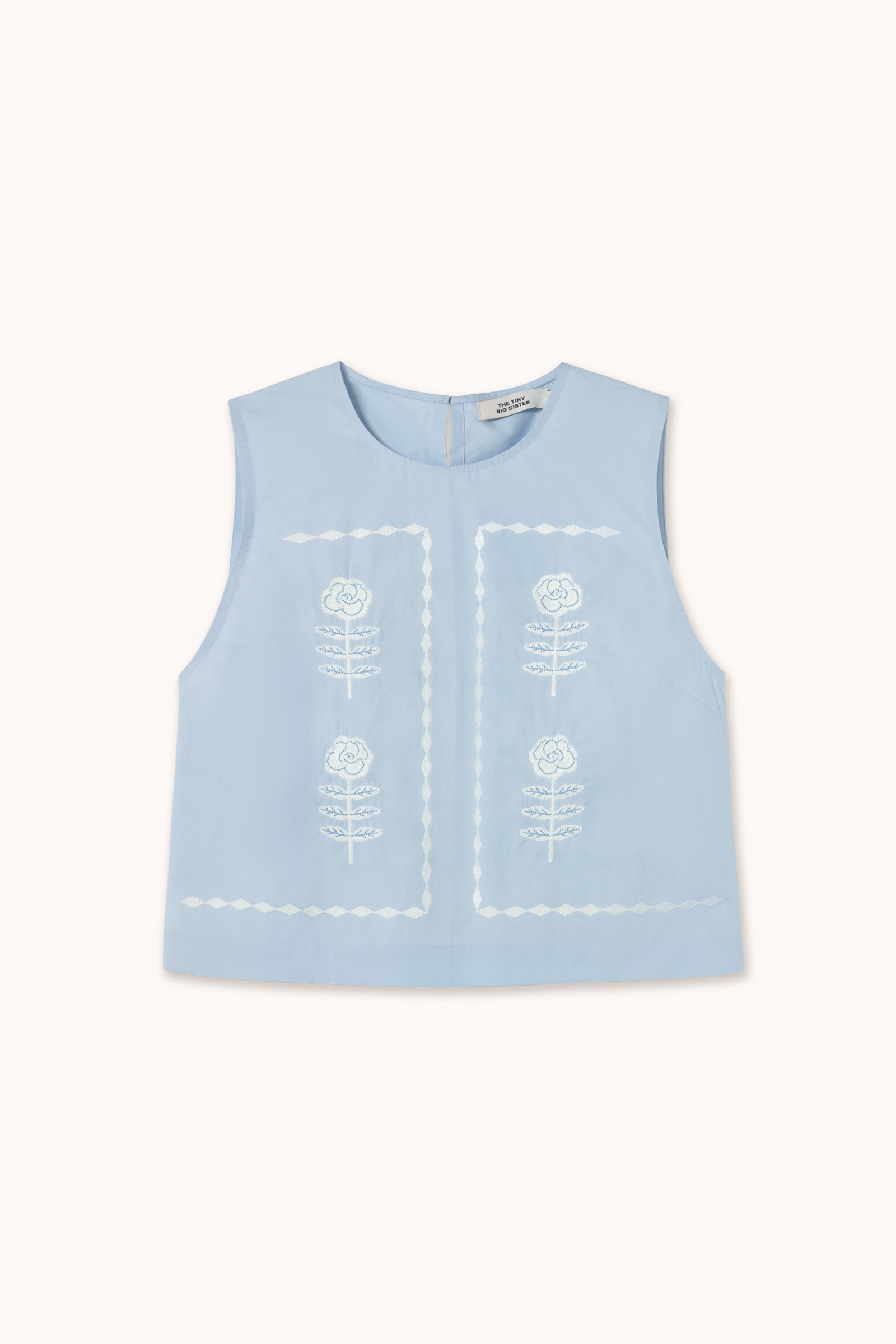 The Tiny Big Sister Embroidered Sleeveless Top - Blue features delicate white floral embroidery on the front, showcased against a plain background.