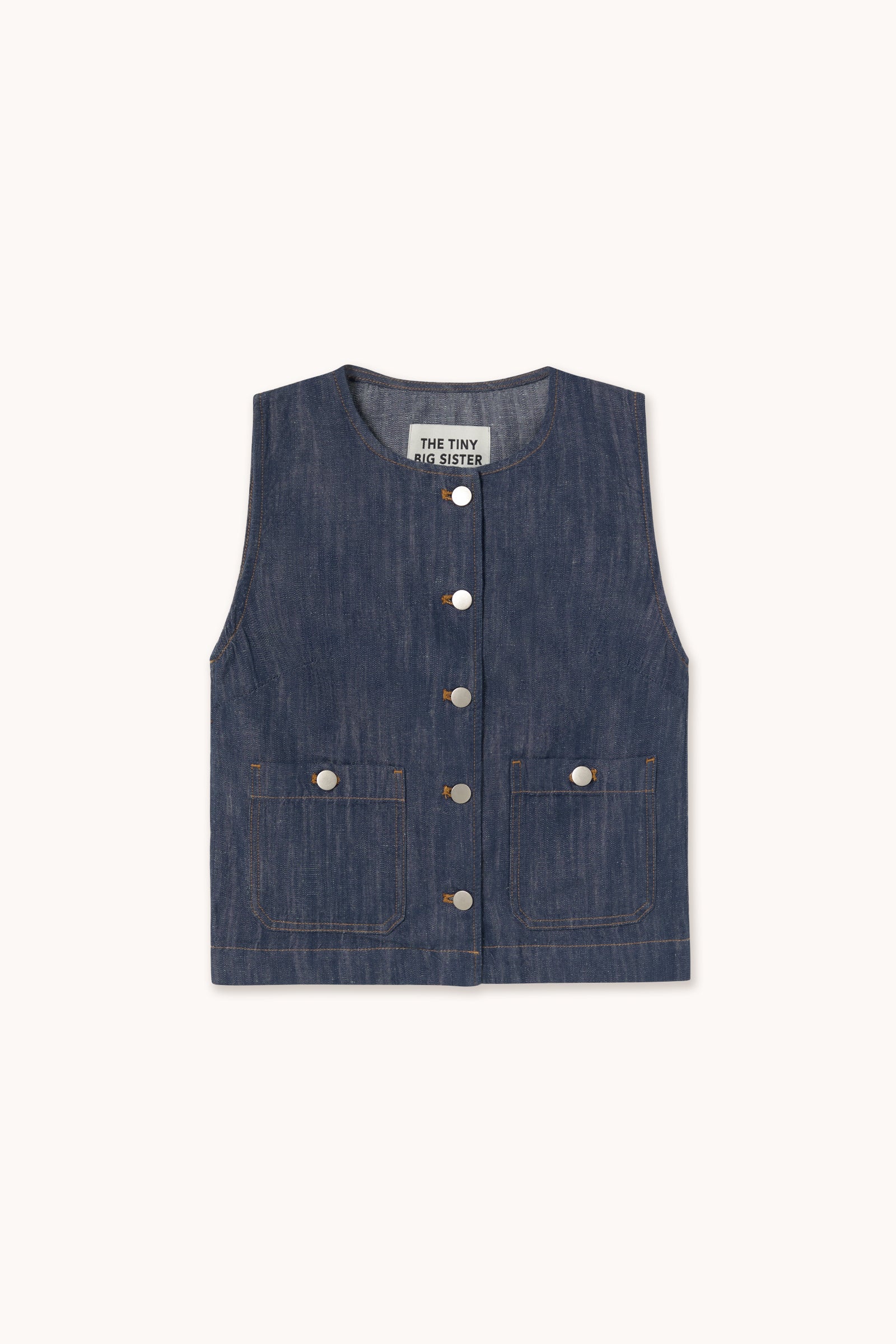 The Tiny Big Sister Linen/Cotton Blend Vest in indigo features a sleeveless design, front buttons, two lower pockets, and contrast stitching for a utility-inspired look, displayed on a plain background.