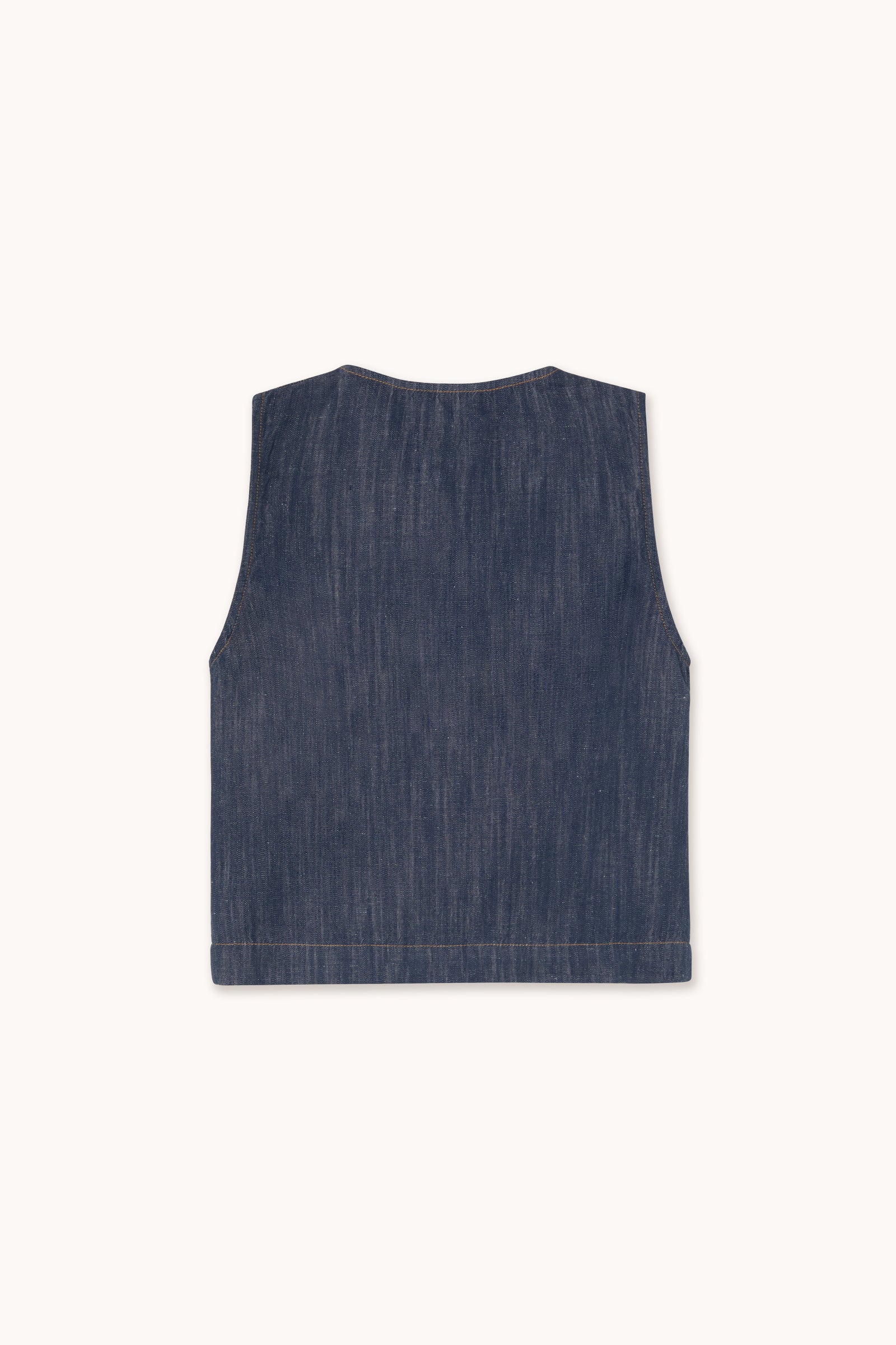 The Linen/Cotton Blend Vest in Indigo from Tiny Big Sister is sleeveless and shown from the back on a white background—a stylish piece to embrace the utility trend.