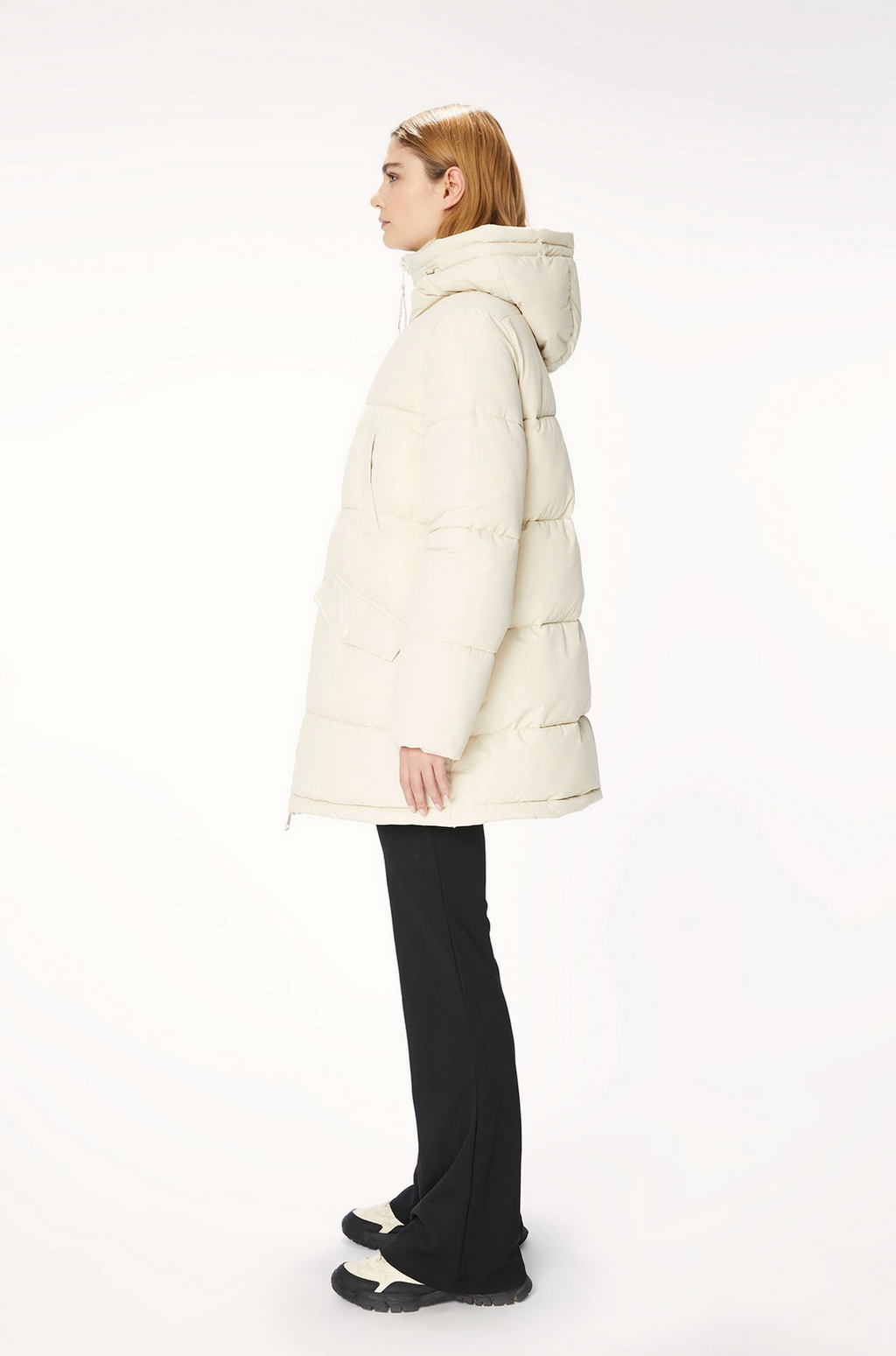 Model wears cream puffer jacket. Side view.