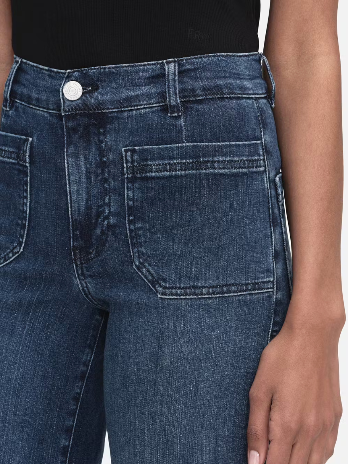 Model wears wide leg jeans in a dark wash. Features front pockets.