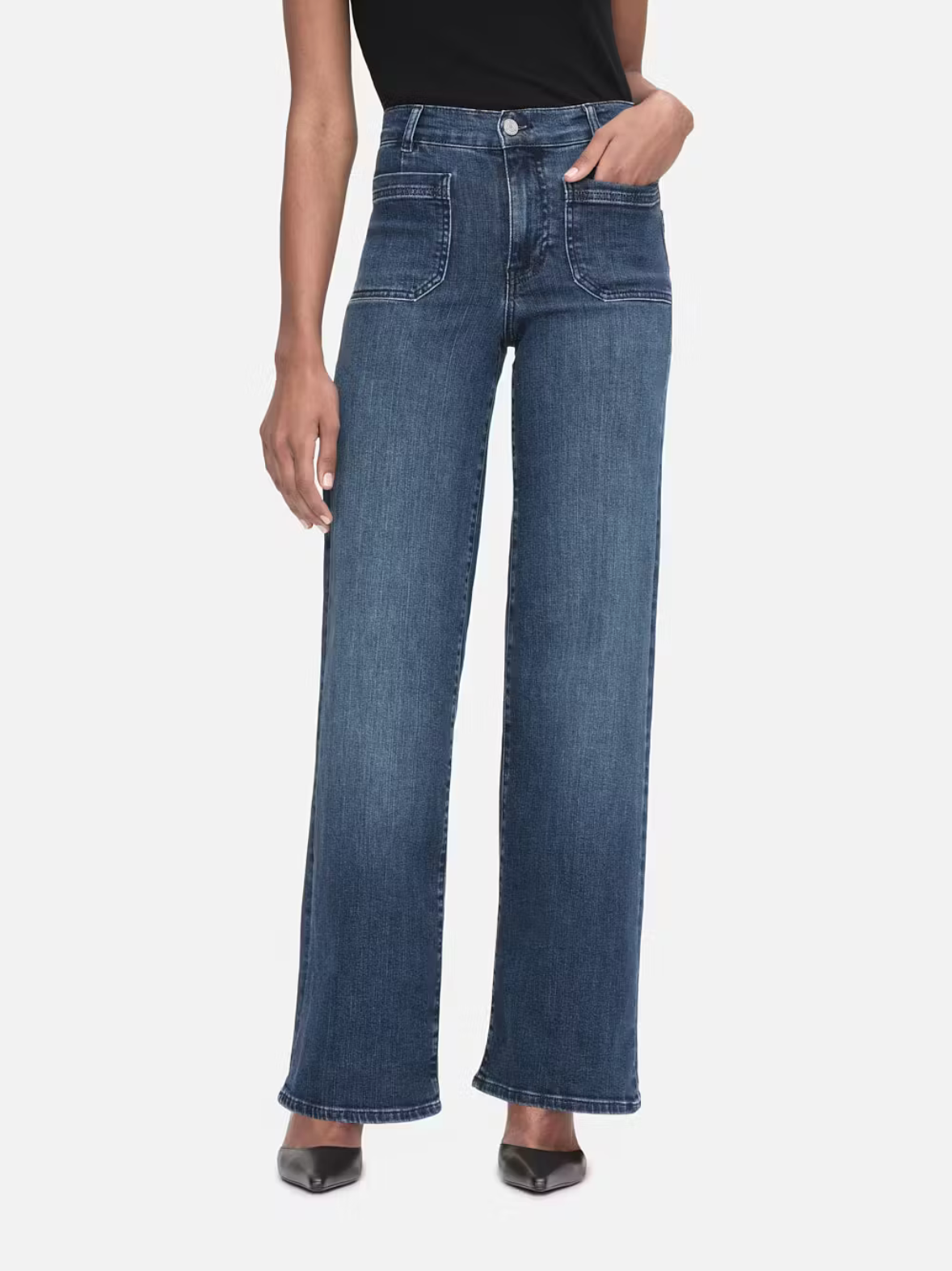 Model wears wide leg jeans in a dark wash. Features front pockets.