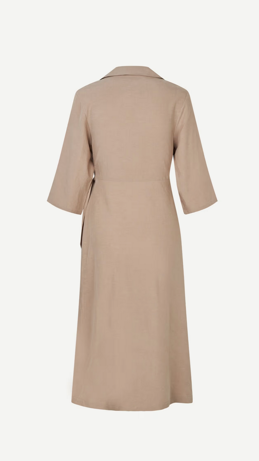 Back view of the Sahani Dress - Greige by Samsøe Samsøe, a tan knee-length midi wrap dress made from recycled polyester with elbow-length sleeves and a collar.