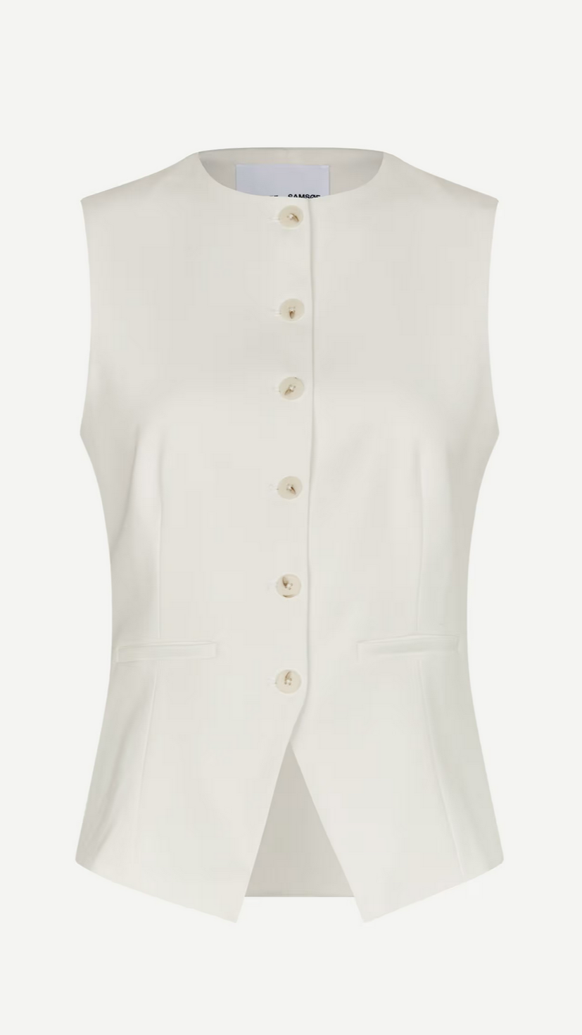 The Saruma Vest - Egret by Samsøe Samsøe is an eco-friendly, white sleeveless button-up made from recycled polyester. It has a round neckline, seven buttons, and two waist pockets.