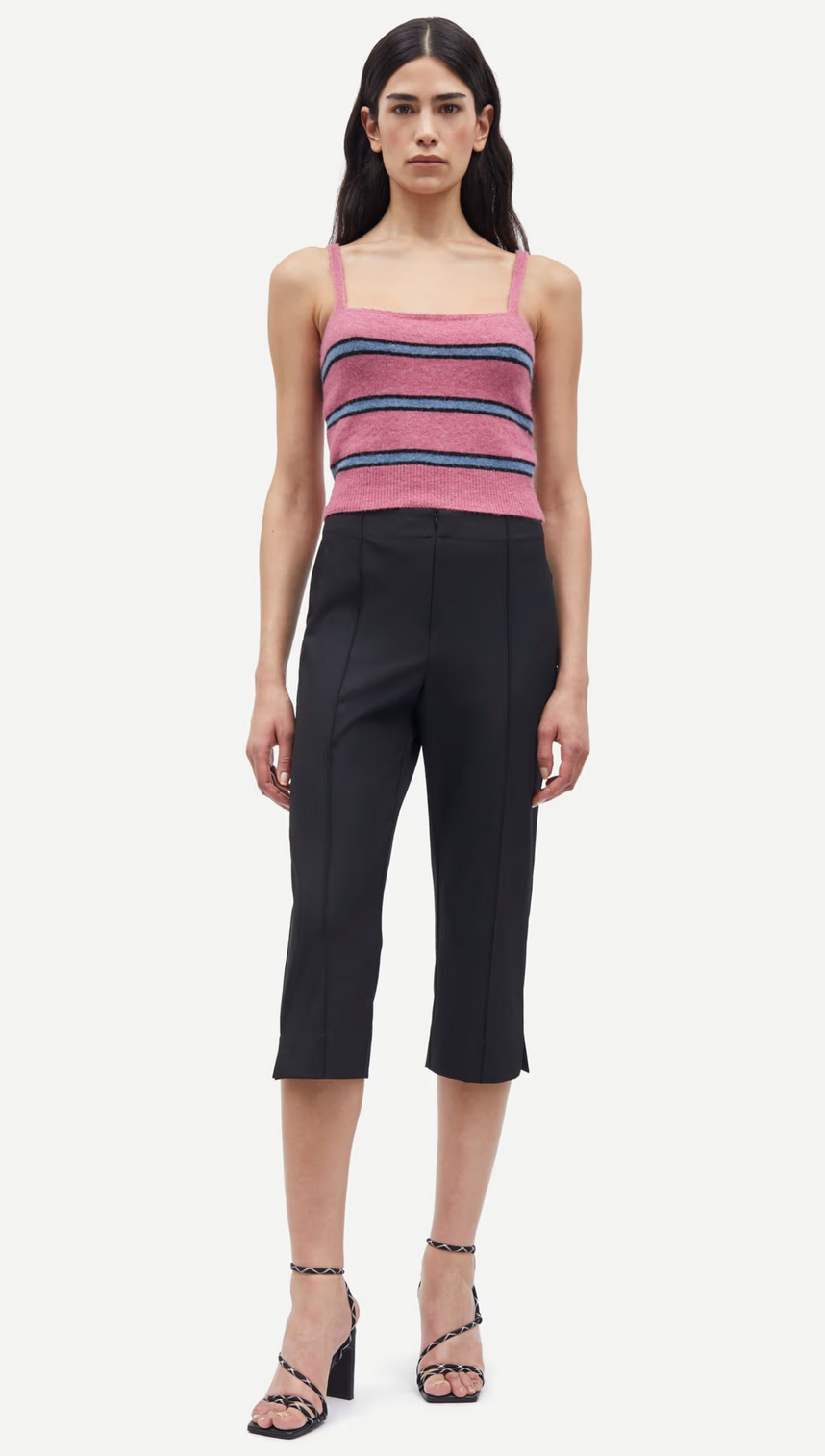 A person in a pink and black striped sleeveless top, Sacorla Cropped Trousers by Samsøe Samsøe, and black high-heeled sandals poses against a plain white background.