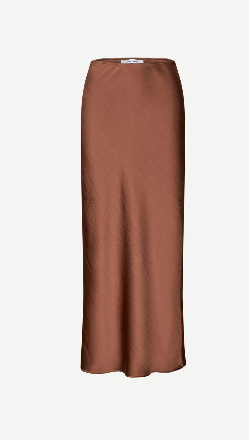 The Saagneta Long Satin Skirt in Tortoise Shell by Samsøe Samsøe is a brown slim-fit midi with a straight cut and subtle sheen, crafted from recycled polyester and shown against a plain white background.