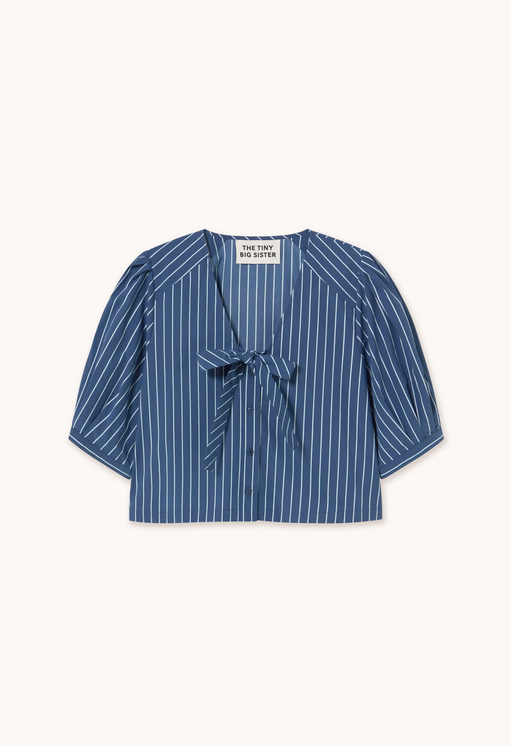 The Tie Detail Blouse - Navy by Tiny Big Sister features a blue and white pinstripe design, short puffed sleeves, a front tie at the collar, and button-down closure.