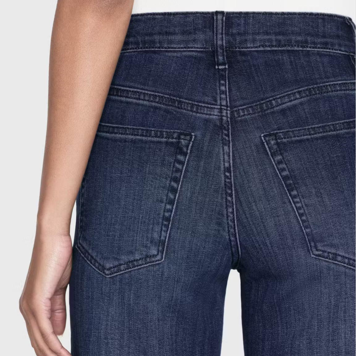 woman wearing blue jeans, back pocket view frame denim