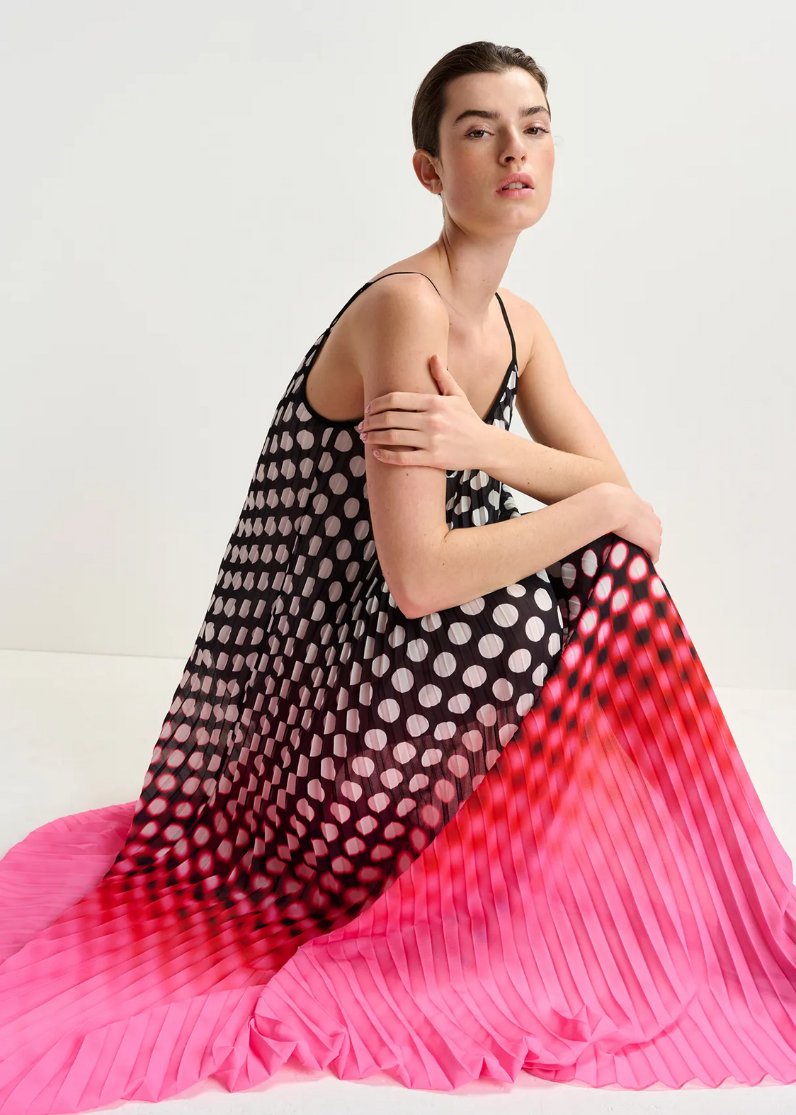 model wears the Hyacinth patterned dress with black, white, red and pink polka dots, thin straps, by essentiel antwerp