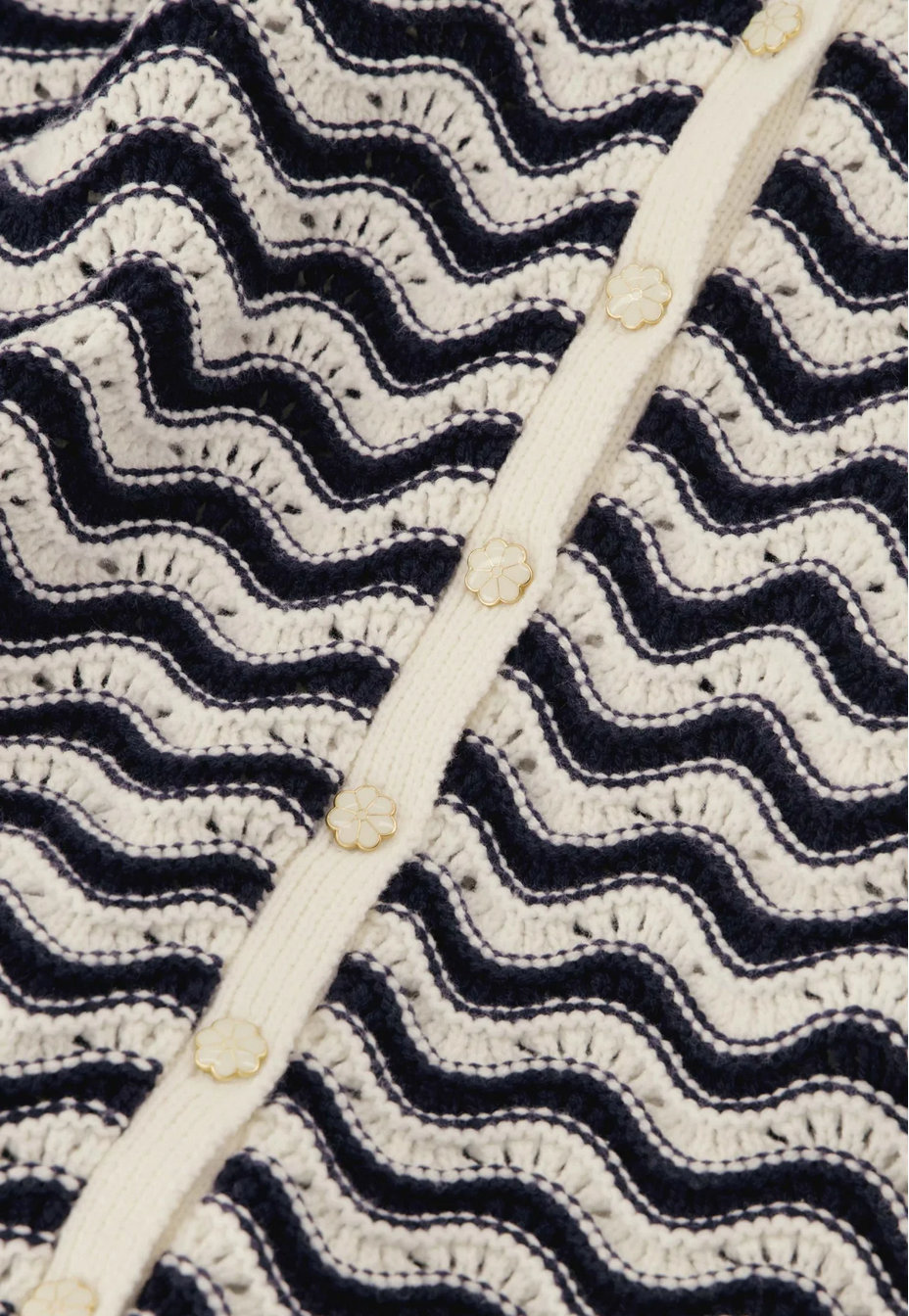 close up image of the caro crochet cardigan by fabienne chapot in navy and off white stripes on a white background