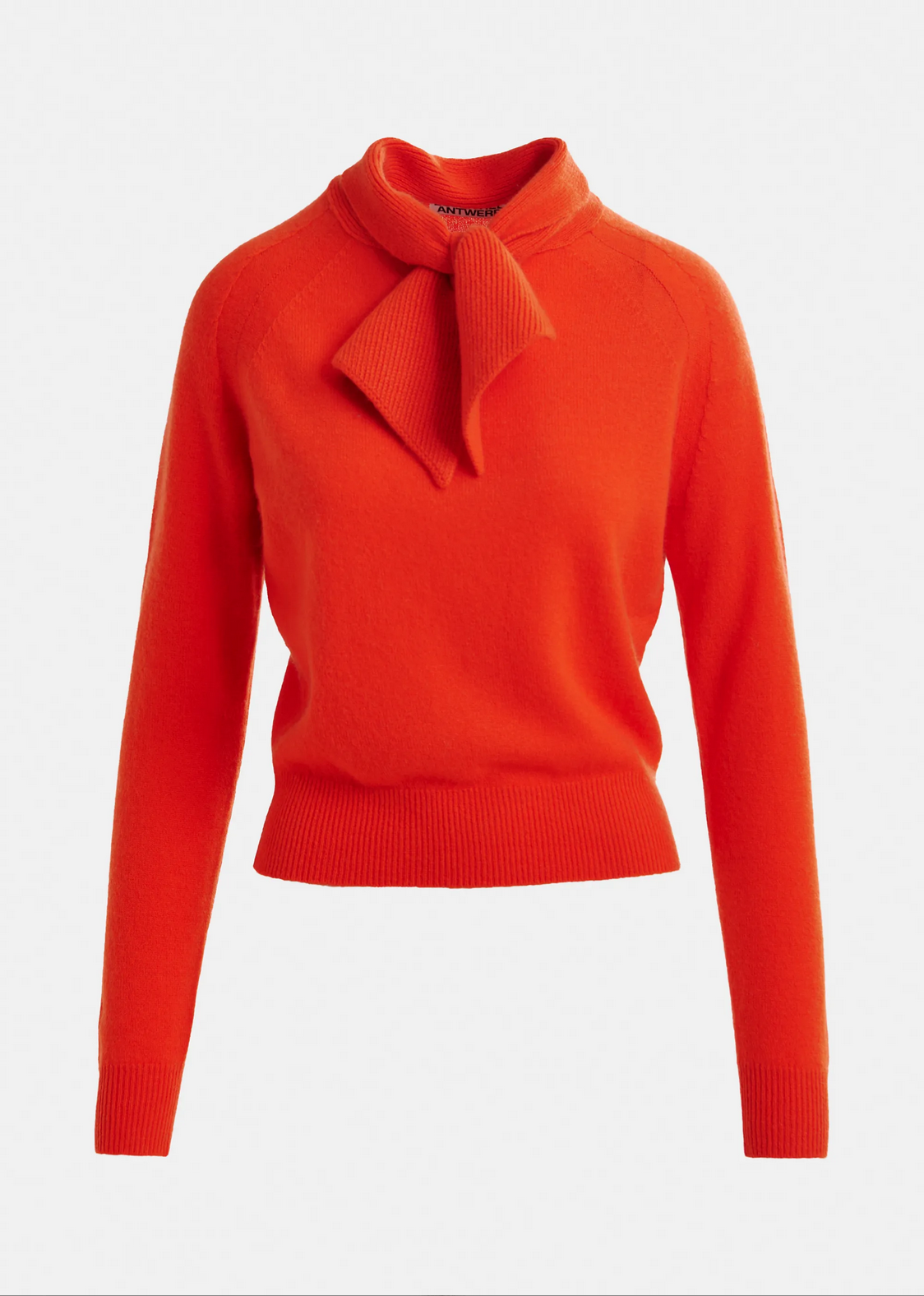 The Invited Cashmere Sweater by Essentiel Antwerp features a bright orange hue, ribbed hem and cuffs, and a matching fabric bow-tie detail at the neckline.