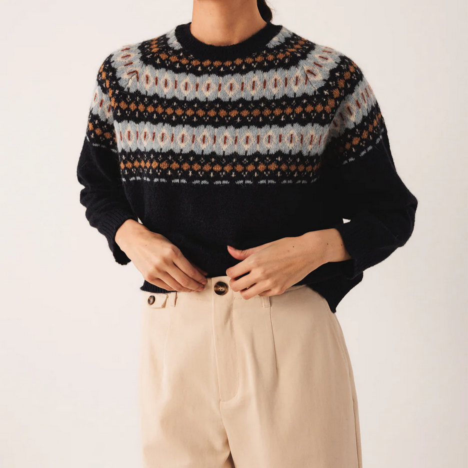 Person wearing a navy fairisle style jacquard patterned sweater