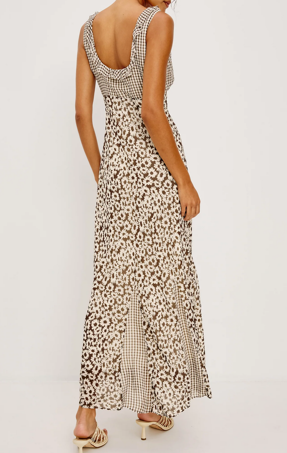 A woman is photographed from behind, wearing the Rails Dahlia Dress in brown gingham—a sleeveless, backless chiffon dress with a ruffle-trimmed neckline—against a plain white background.